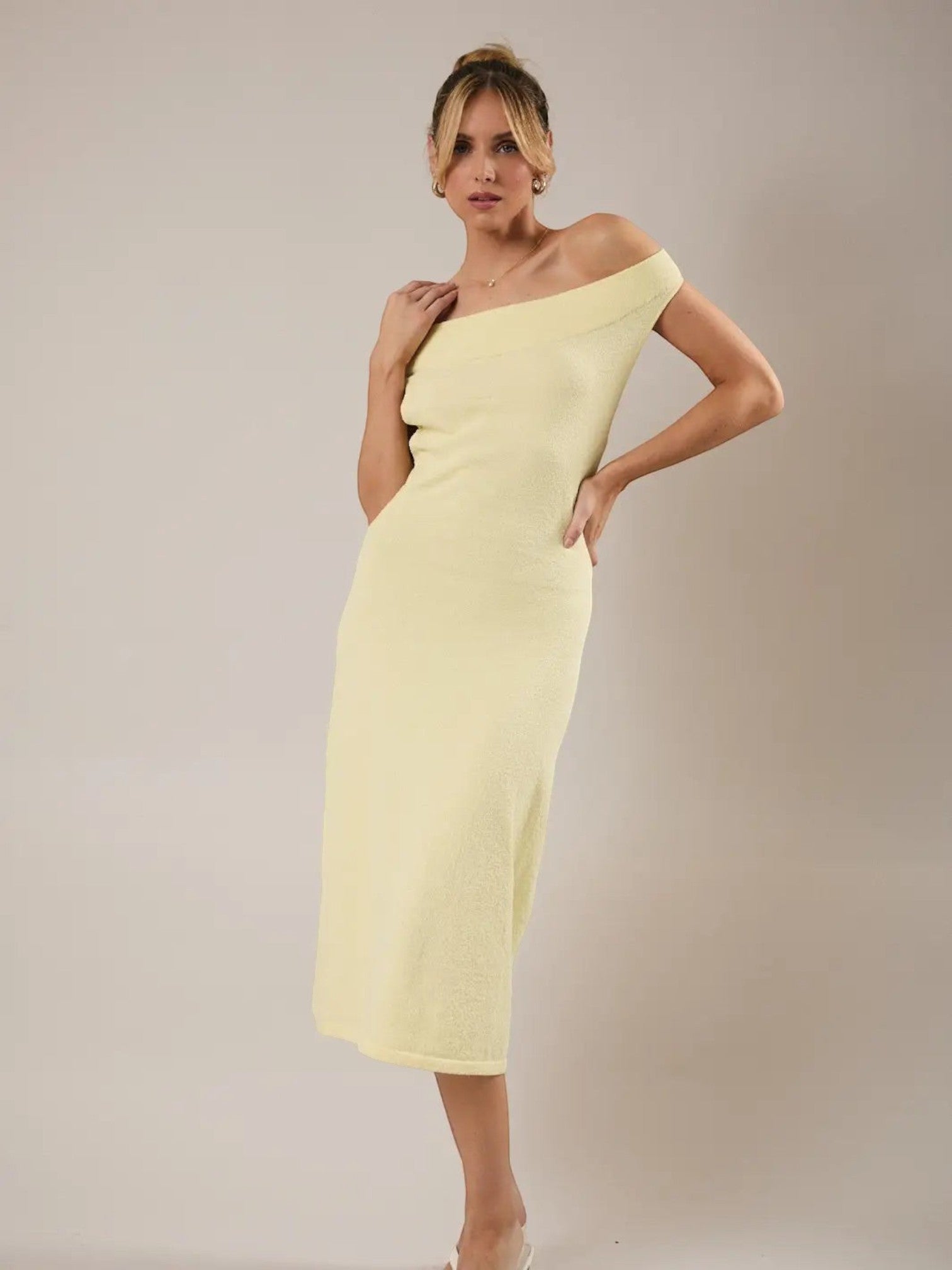 Model wearing a Mialur limoncello yellow off-the-shoulder knit midi dress with a fitted bodice and A-line silhouette.