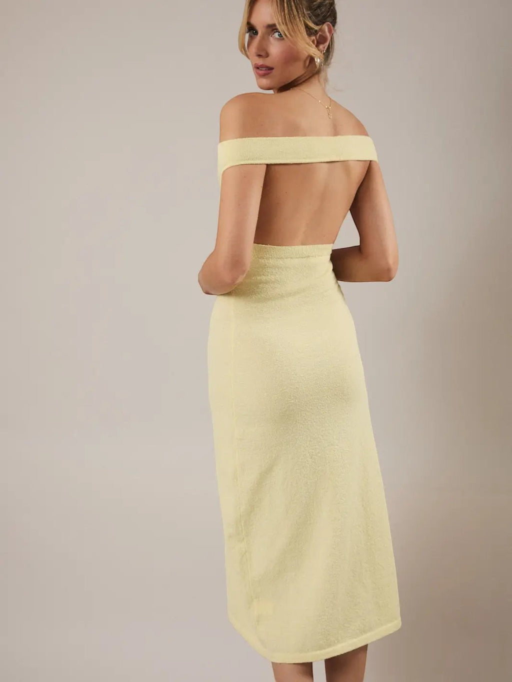 Mialur Limoncello yellow off-the-shoulder knit midi dress with a fitted bodice and open back view on a model.