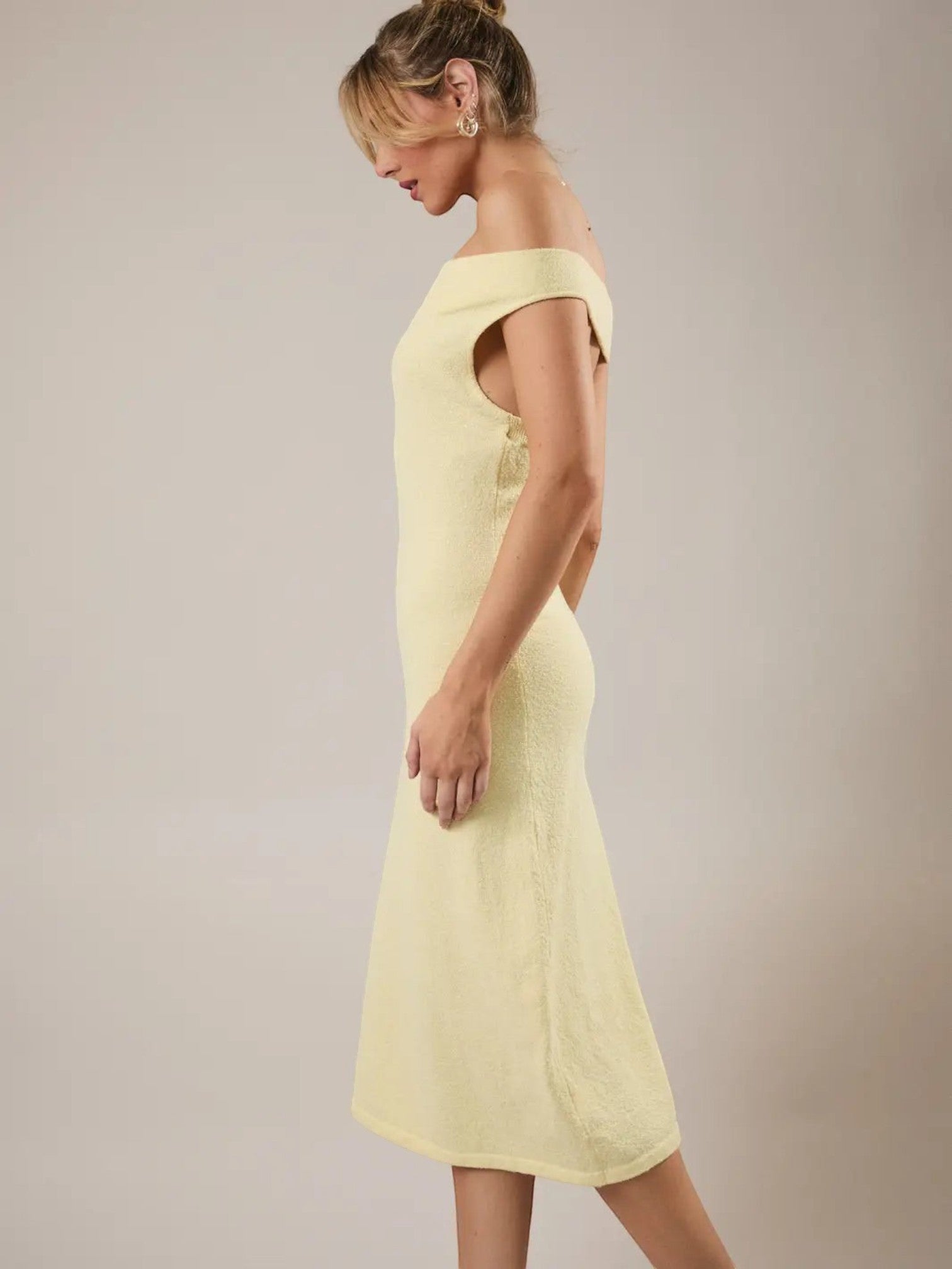 Mialur Limoncello yellow knit midi dress with an off-the-shoulder neckline and fitted A-line silhouette on a model