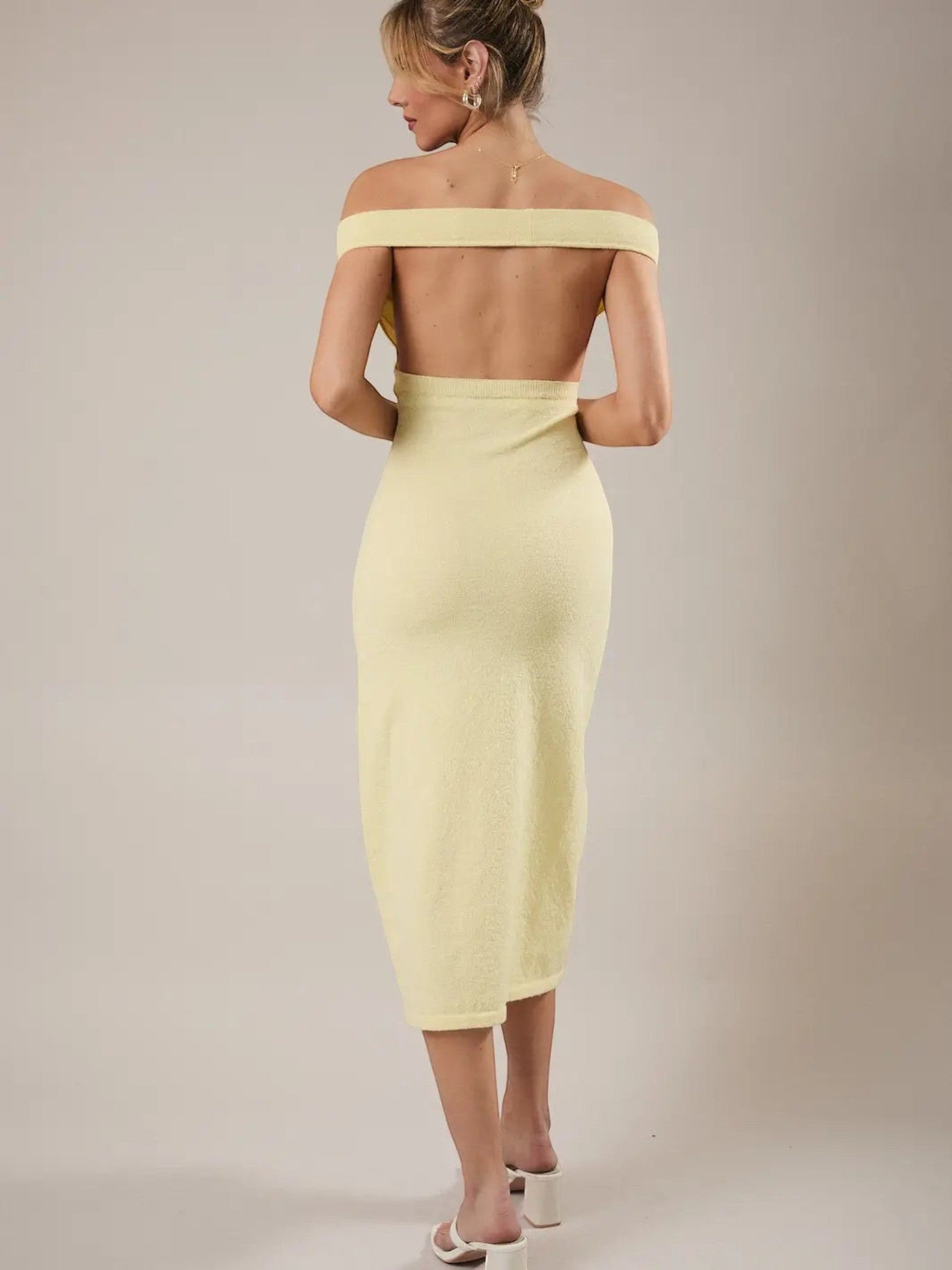 Back view of a Mialur limoncello yellow off-the-shoulder knit midi dress with a fitted bodice on a model.