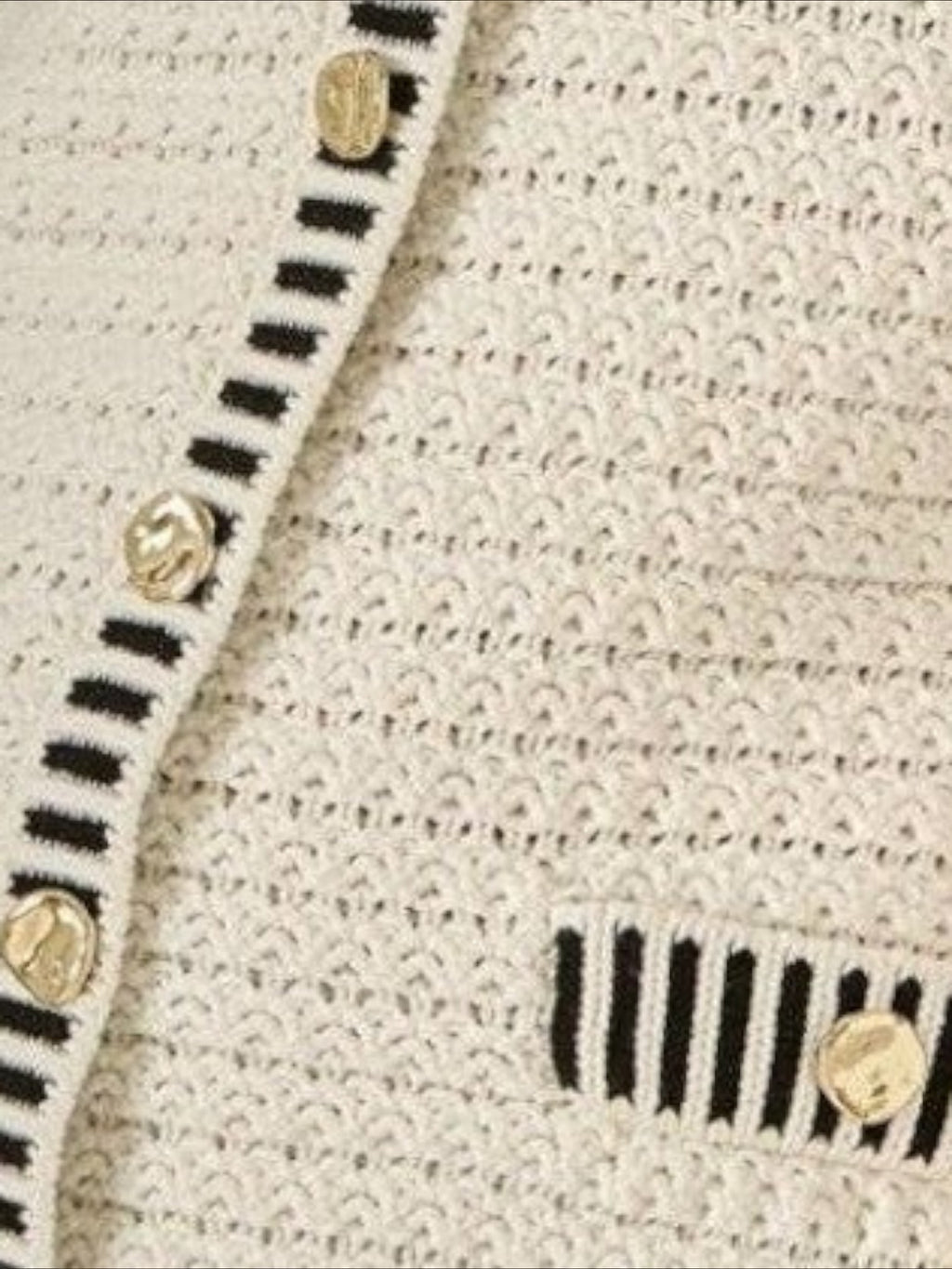 Mialur Madeline contrast knit mini dress in cream with black trim, decorative pockets, and gold-tone button details.