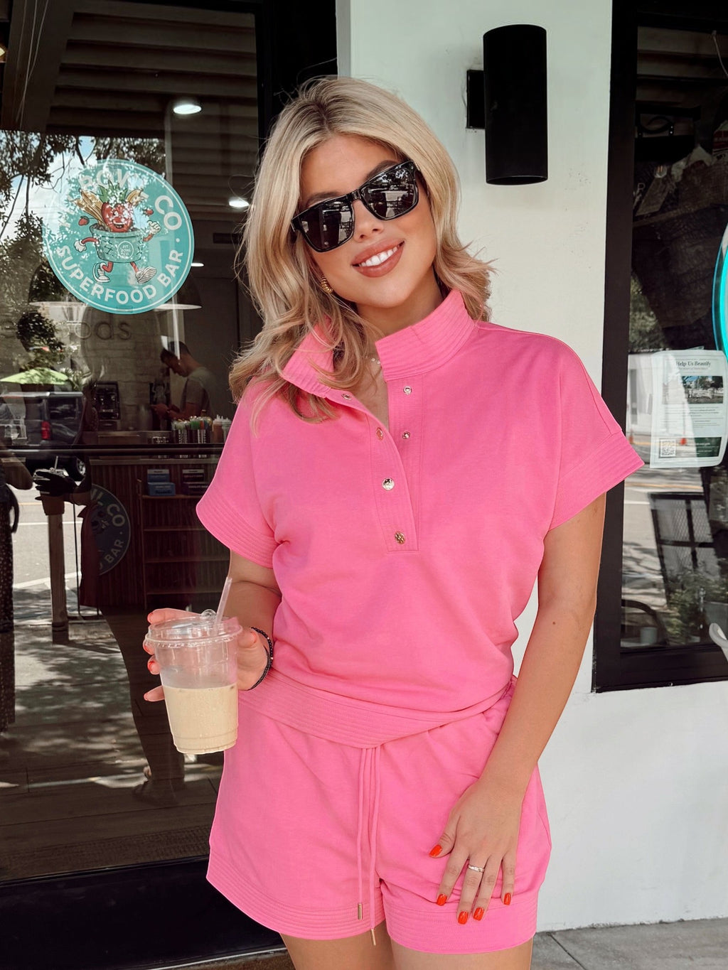 Mialur Malibu Set in vibrant pink featuring a collared short-sleeve top with gold buttons and matching drawstring shorts.