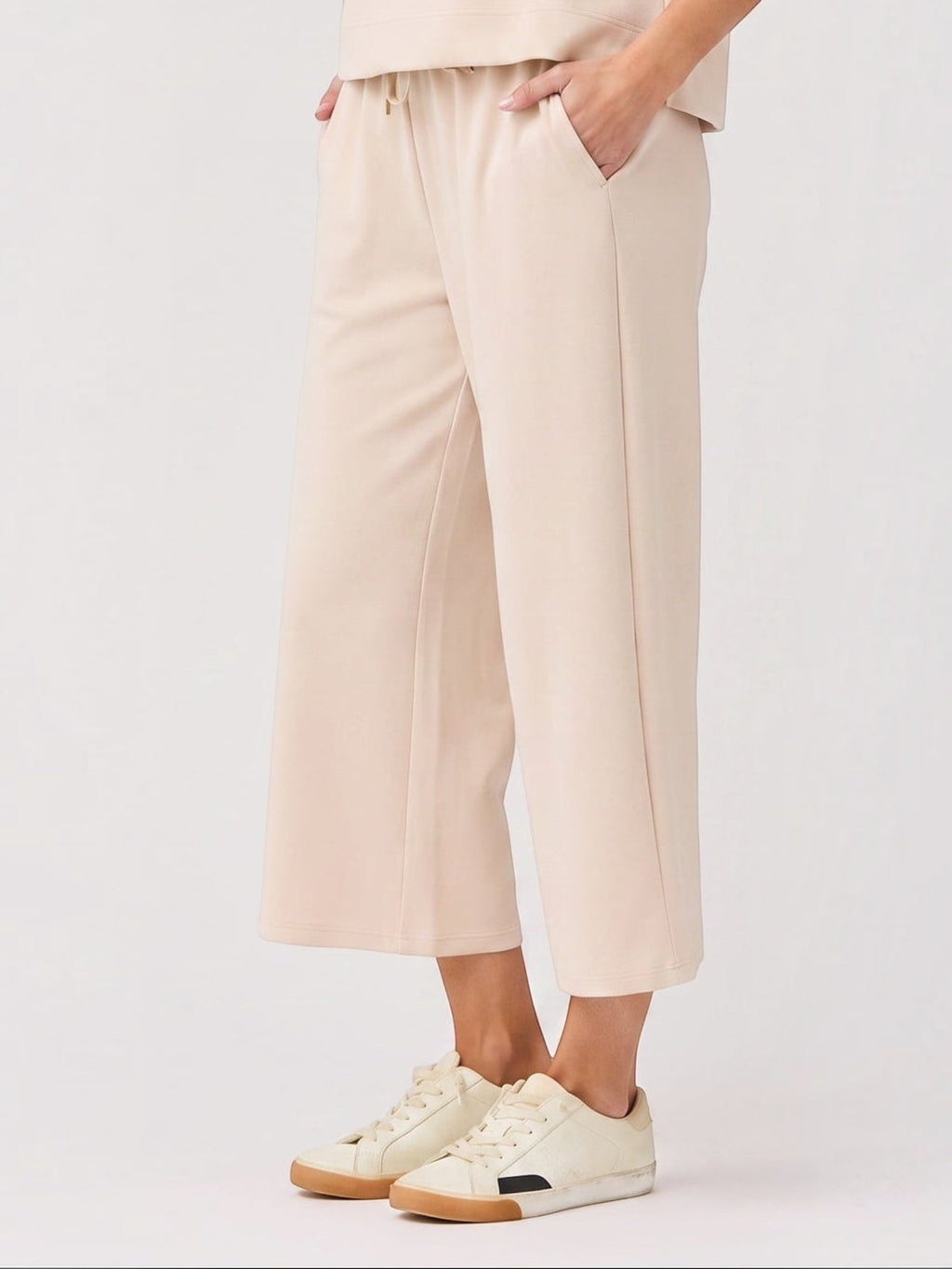 Mialur Marina Pants in sand featuring a relaxed wide-leg silhouette, elastic waistband, and soft lightweight fabric.