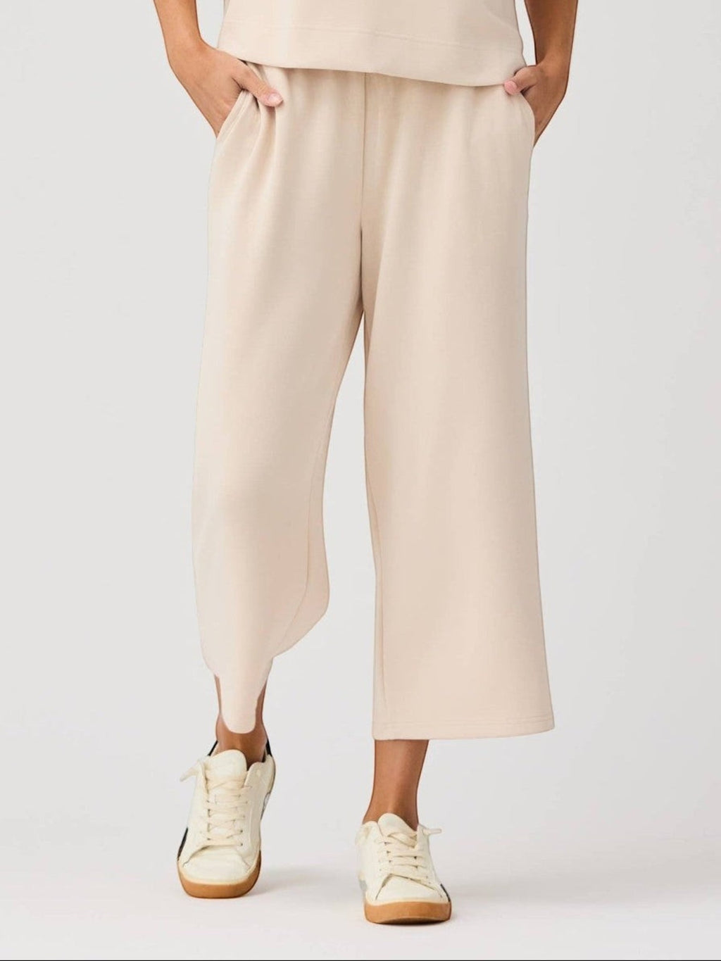 Mialur Marina Pants in sand featuring a relaxed wide-leg silhouette with an elastic waistband and soft stretch fabric.
