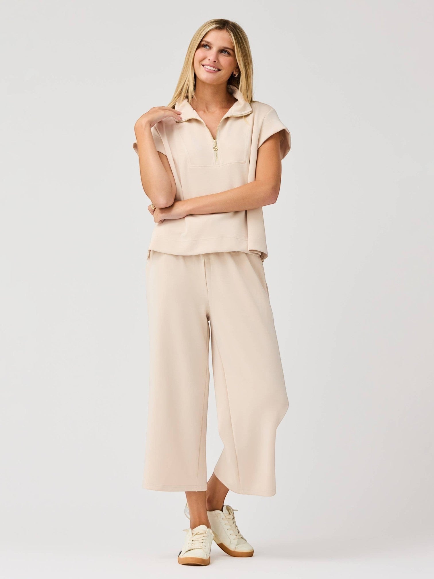 Mialur Marina Pants in sand featuring a relaxed wide-leg silhouette and elastic waistband worn with a matching top.