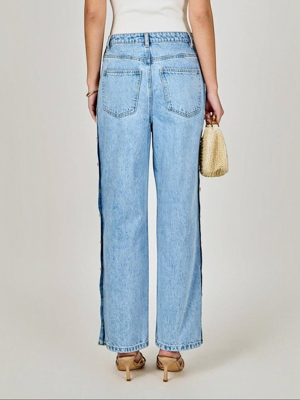 Back view of Mialur Monroe Button Jeans in light-wash blue denim with side button details on a model