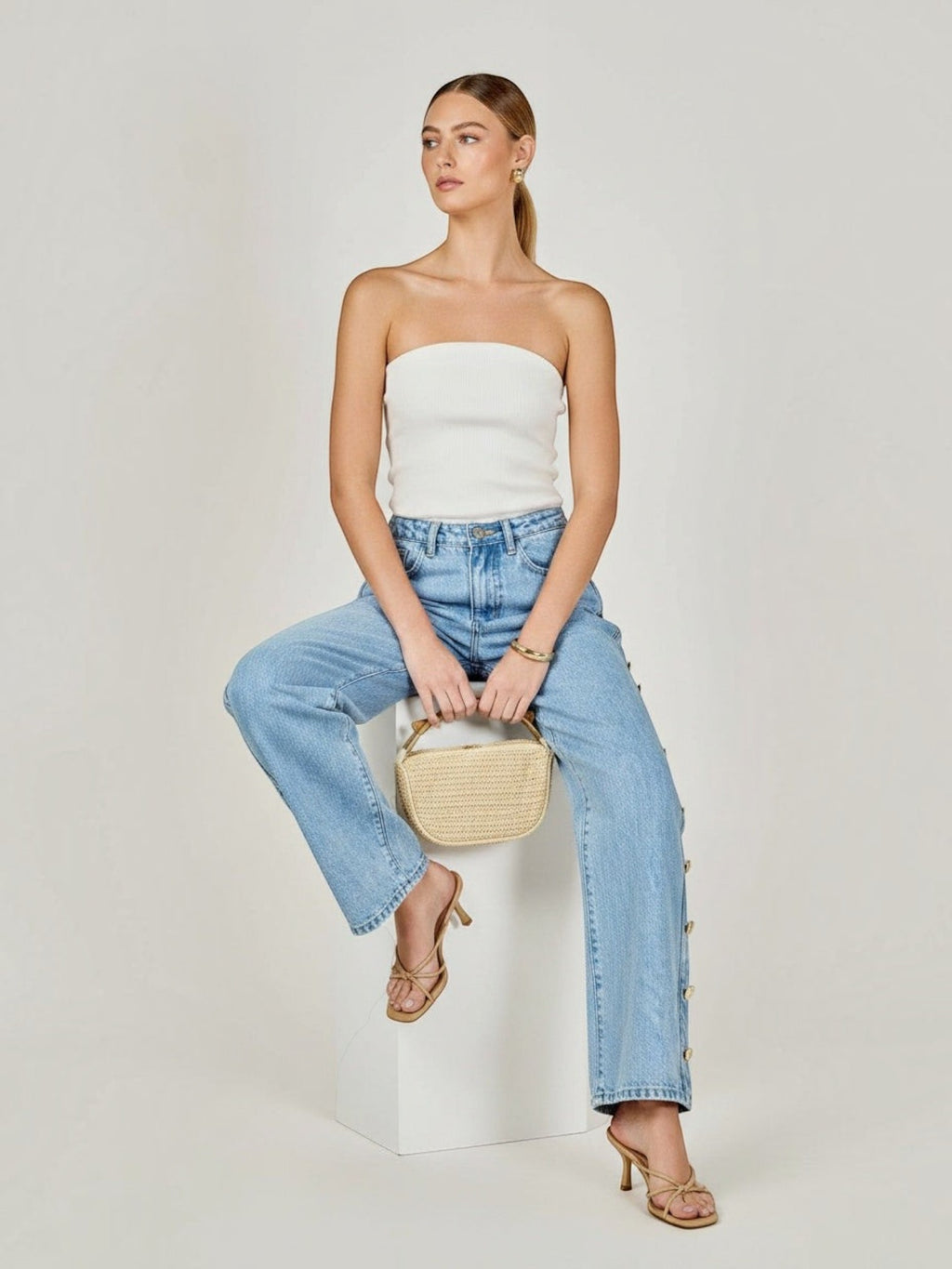 Model wearing Mialur Monroe Button Jeans in light-wash blue with side button detail and a relaxed straight-leg fit.