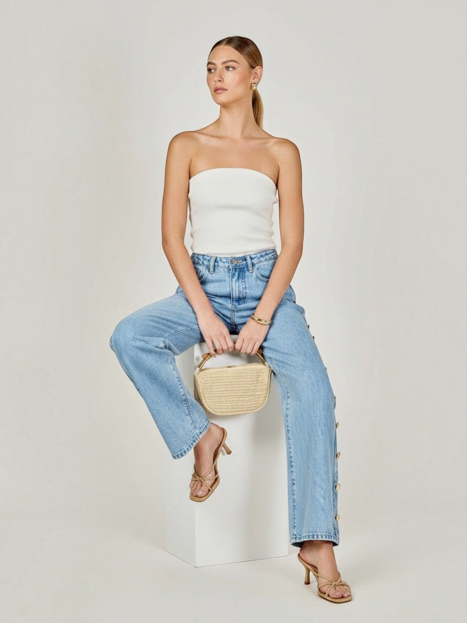 Model wearing Mialur Monroe Button Jeans in light-wash blue with side button detail and a relaxed straight-leg fit.