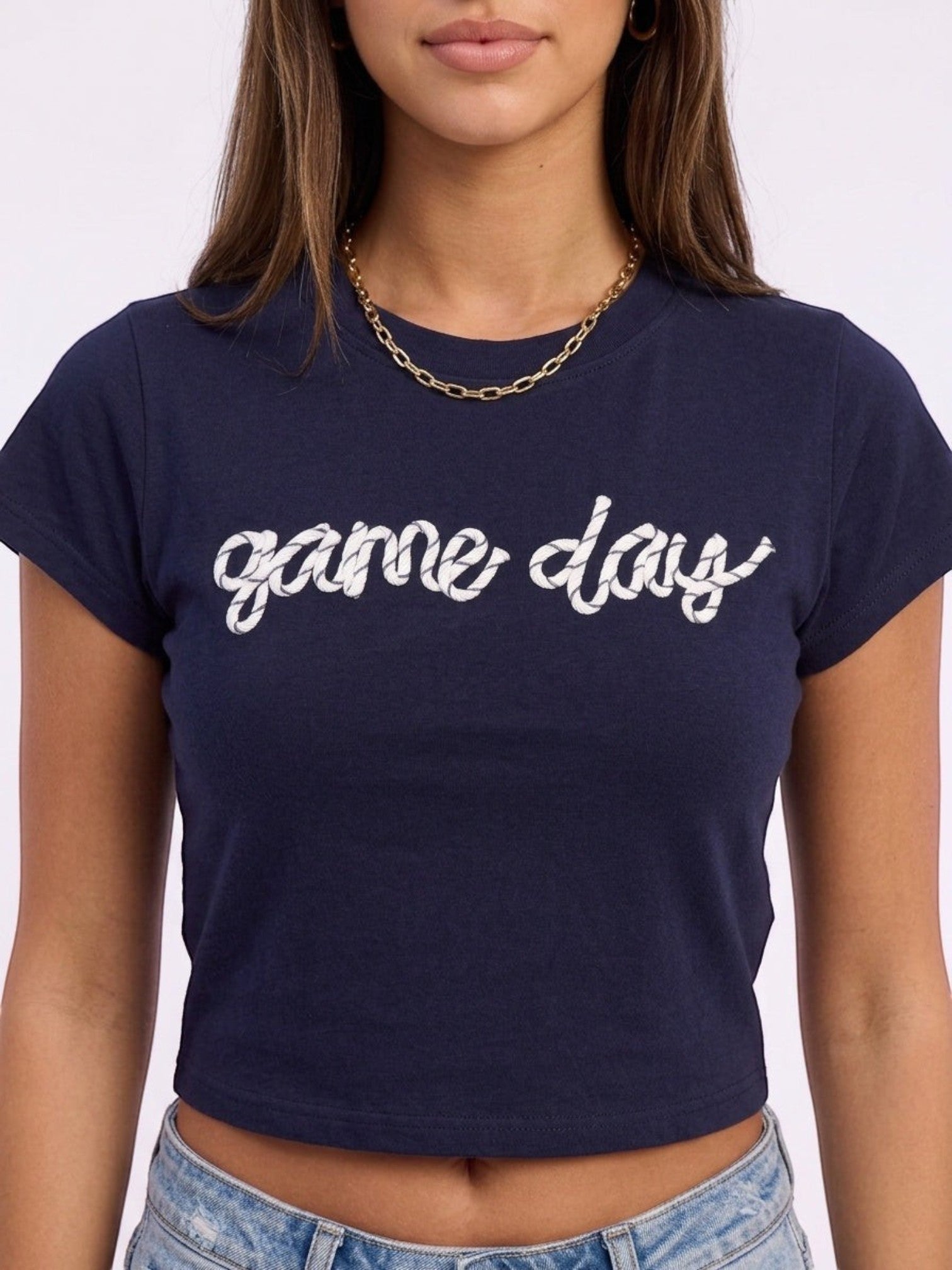 Mialur navy fitted baby tee featuring white game day script text, worn with a gold chain necklace.