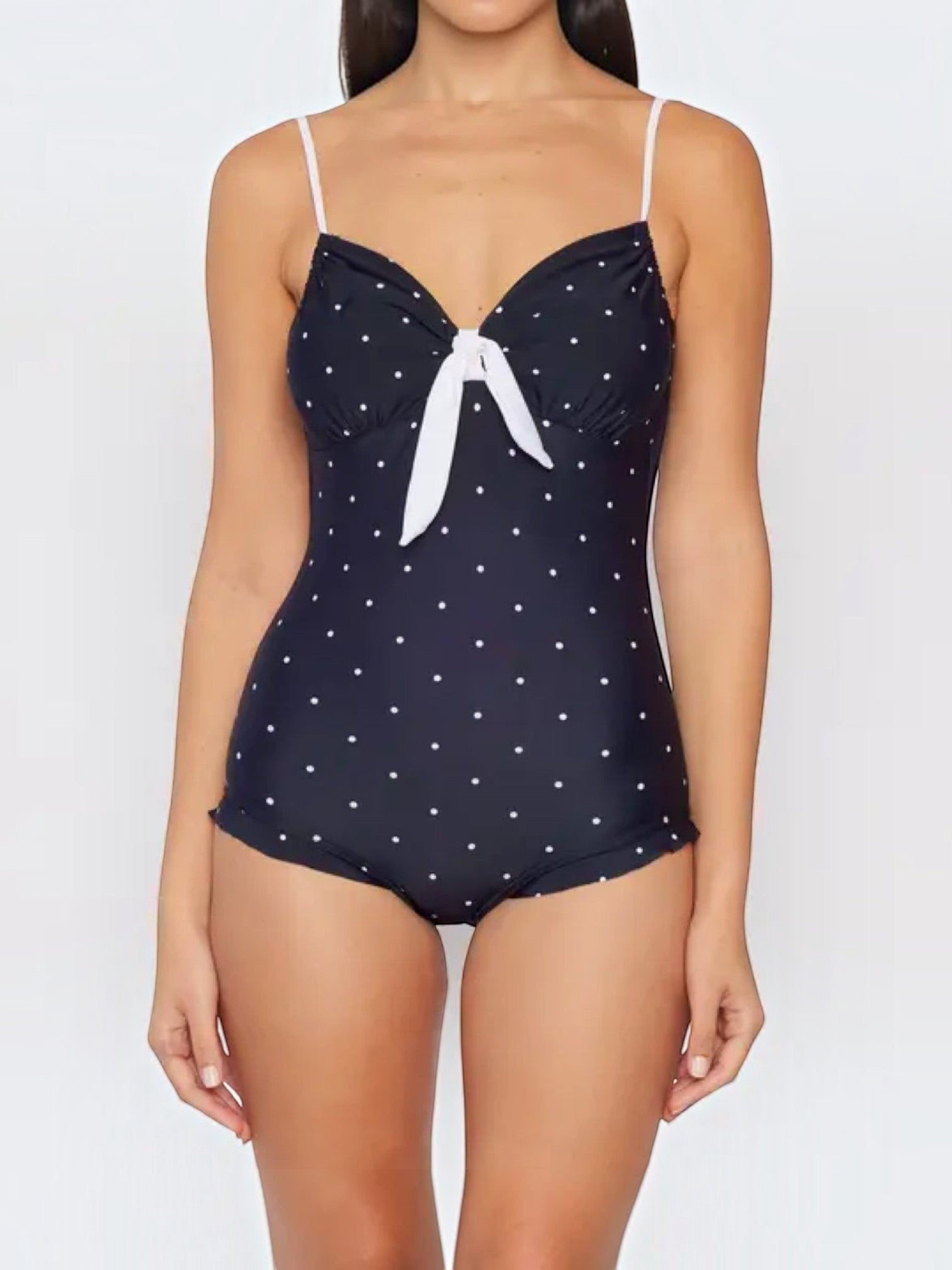 Mialur navy one-piece swimsuit with white polka dots, adjustable straps, and a decorative white bow at the bust.