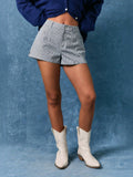 Mialur navy and white pinstripe mid-rise tailored shorts worn with a navy cardigan and white western boots