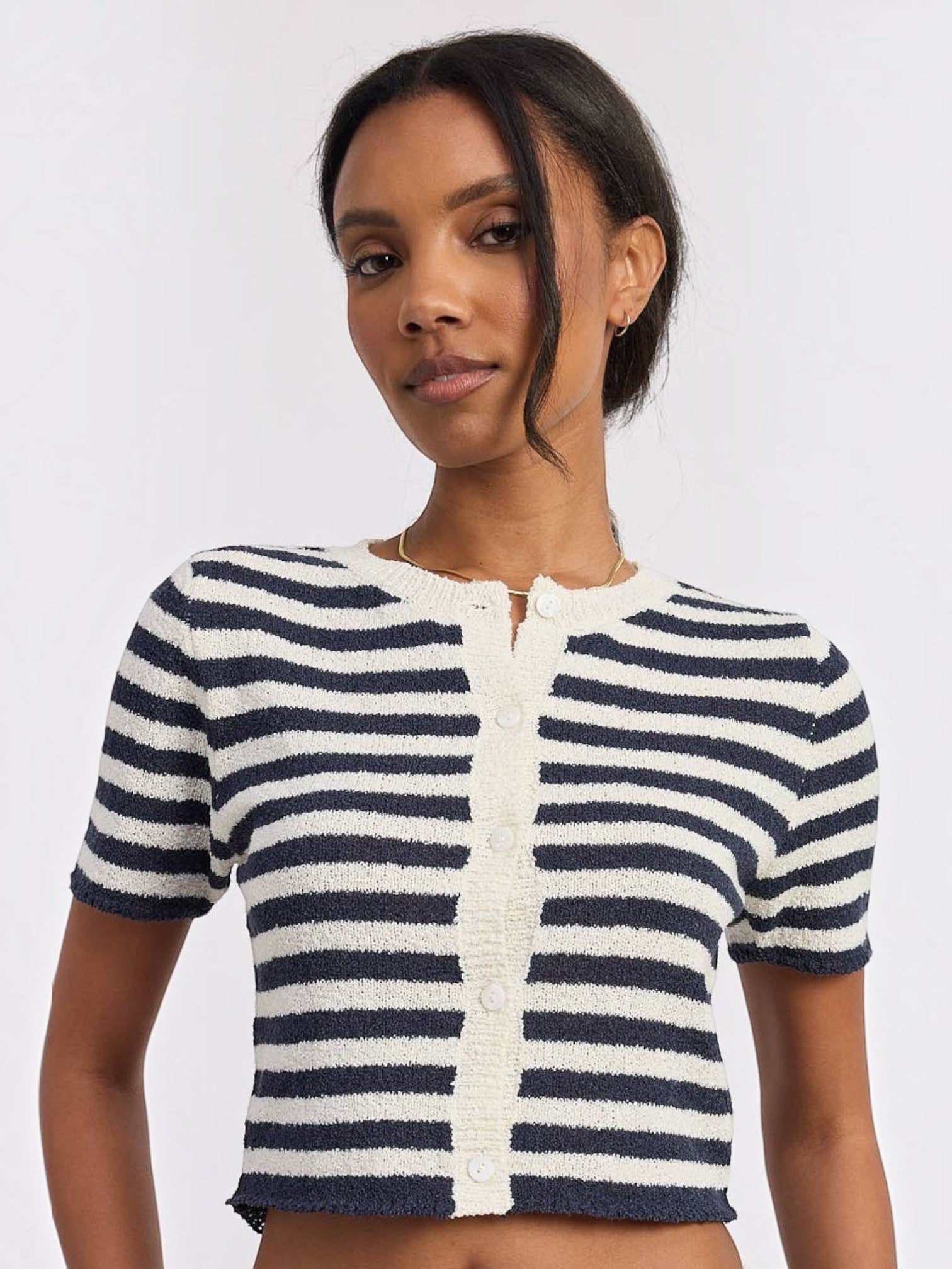 Model wearing a Mialur navy and white striped short-sleeve knit top with a button-front placket and cropped fit.