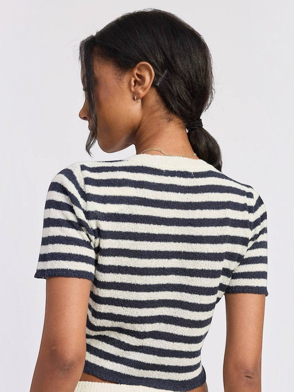 Back view of a woman wearing a Mialur navy and white horizontal striped short-sleeve textured knit top.