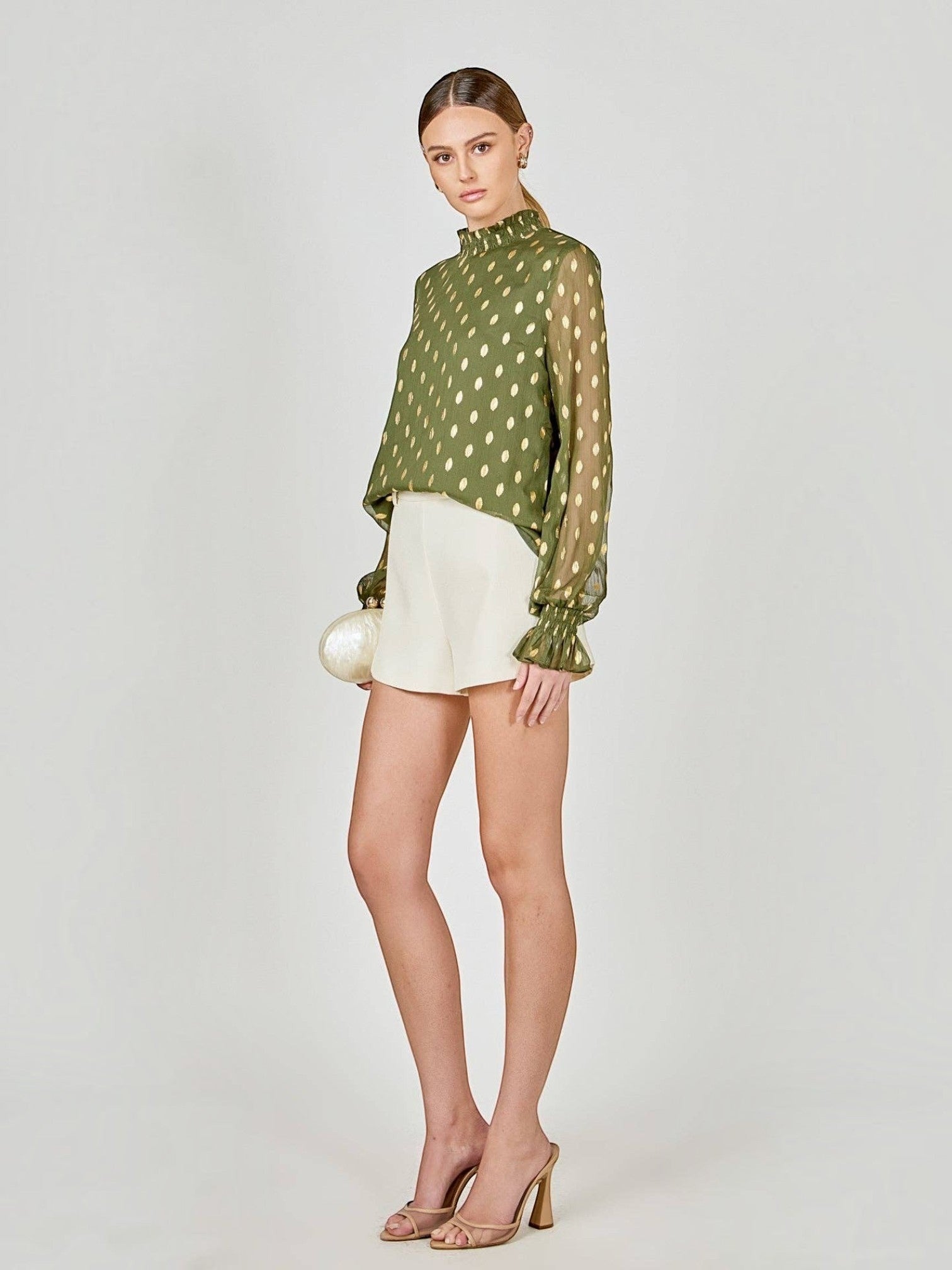 Mialur olive green chiffon blouse with metallic polka dots, high ruffled neckline, and long ruffle-trimmed sleeves.