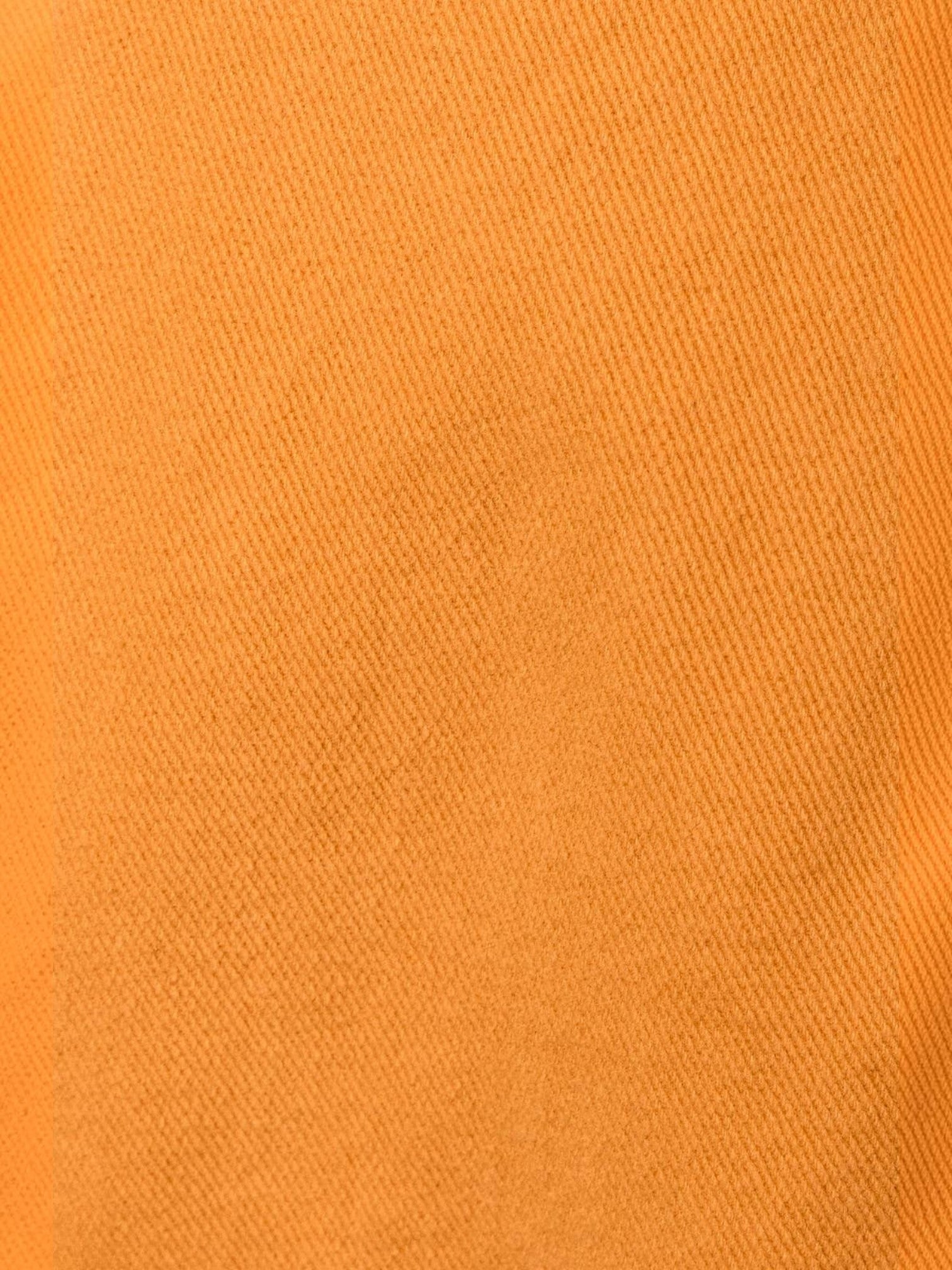 Close-up of vibrant sunset orange 100% cotton fabric from the Mialur Sorrento Sunset Romper