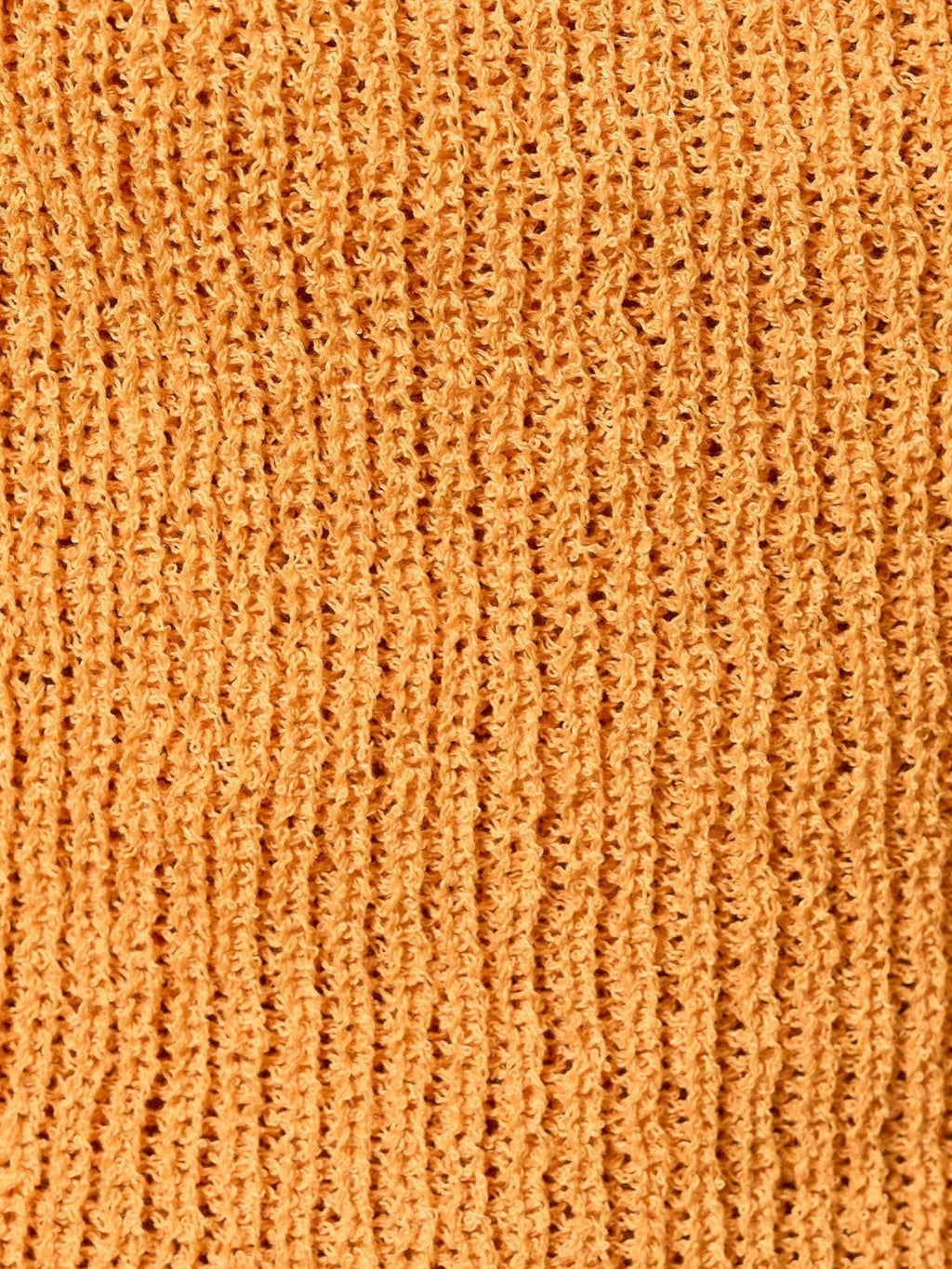 Close-up of the soft orange knit fabric texture of the Mialur Isla Halter Top.