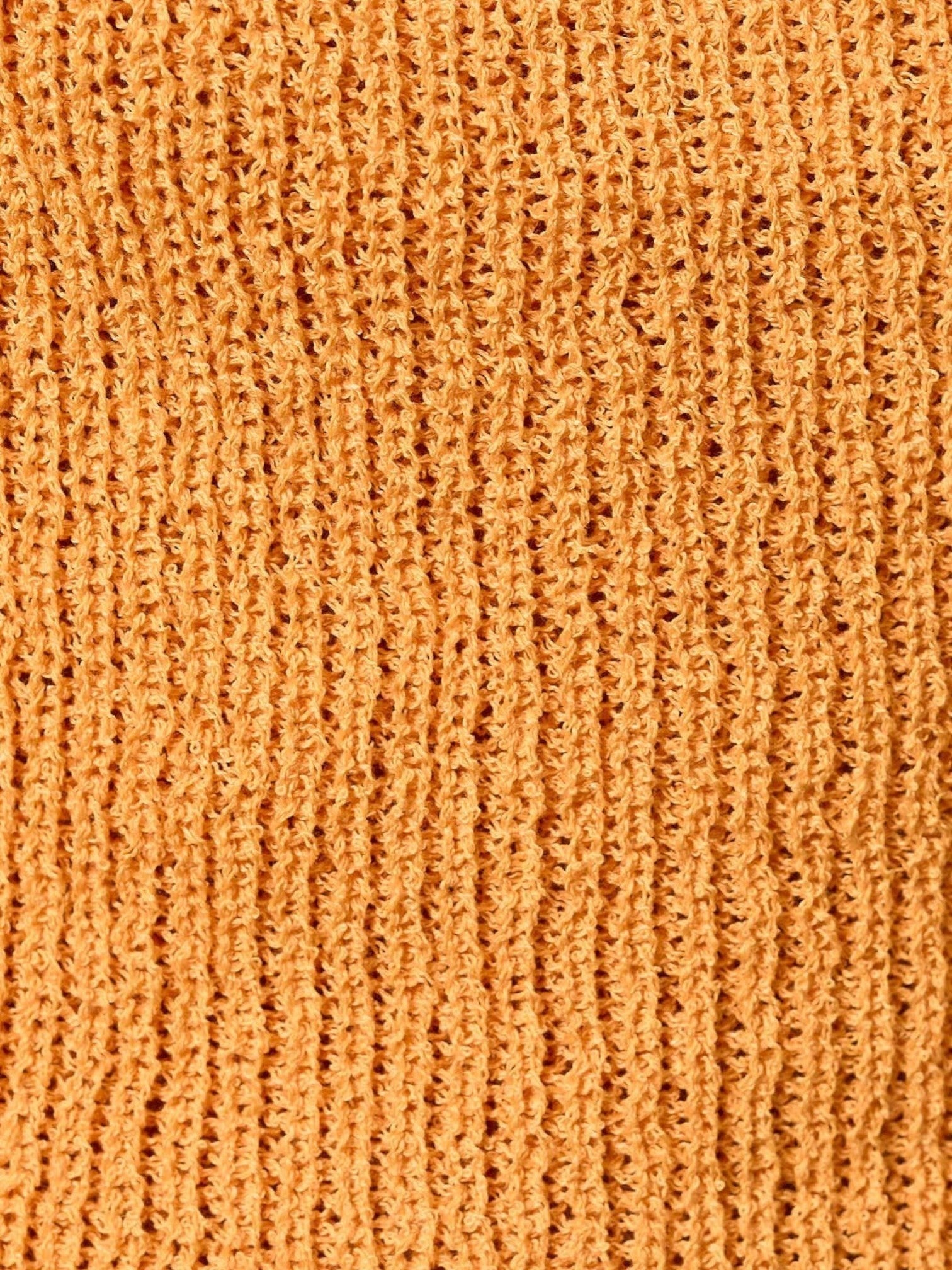 Close-up of the soft orange knit fabric texture of the Mialur Isla Halter Top.