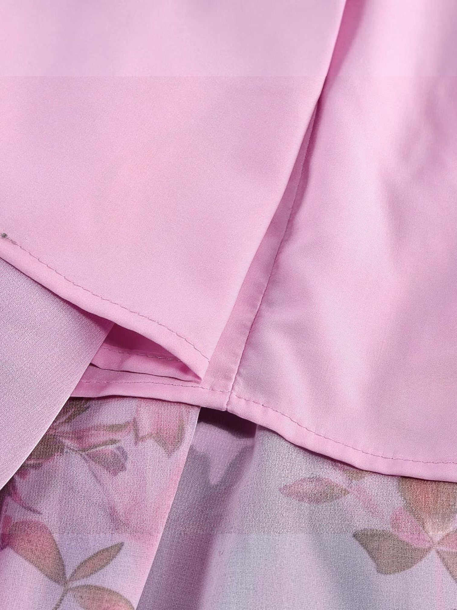 Close-up of Mialur pink floral maxi dress fabric showing layered ruffles and soft floral print texture.