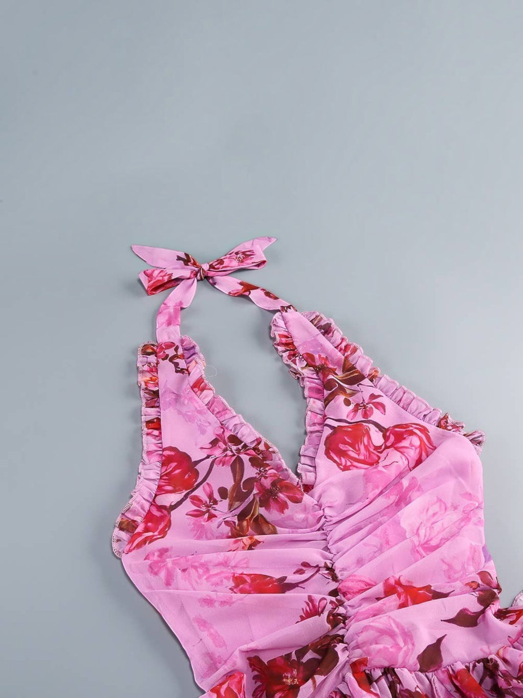 Mialur pink floral maxi dress featuring a halter neckline with tie detail and cascading ruffle trim on the bodice.