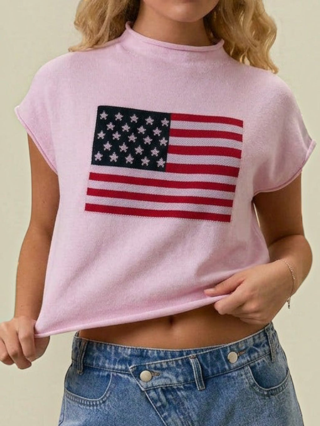 Mialur pink mock neck top with American flag graphic and relaxed drop shoulder fit worn with denim jeans