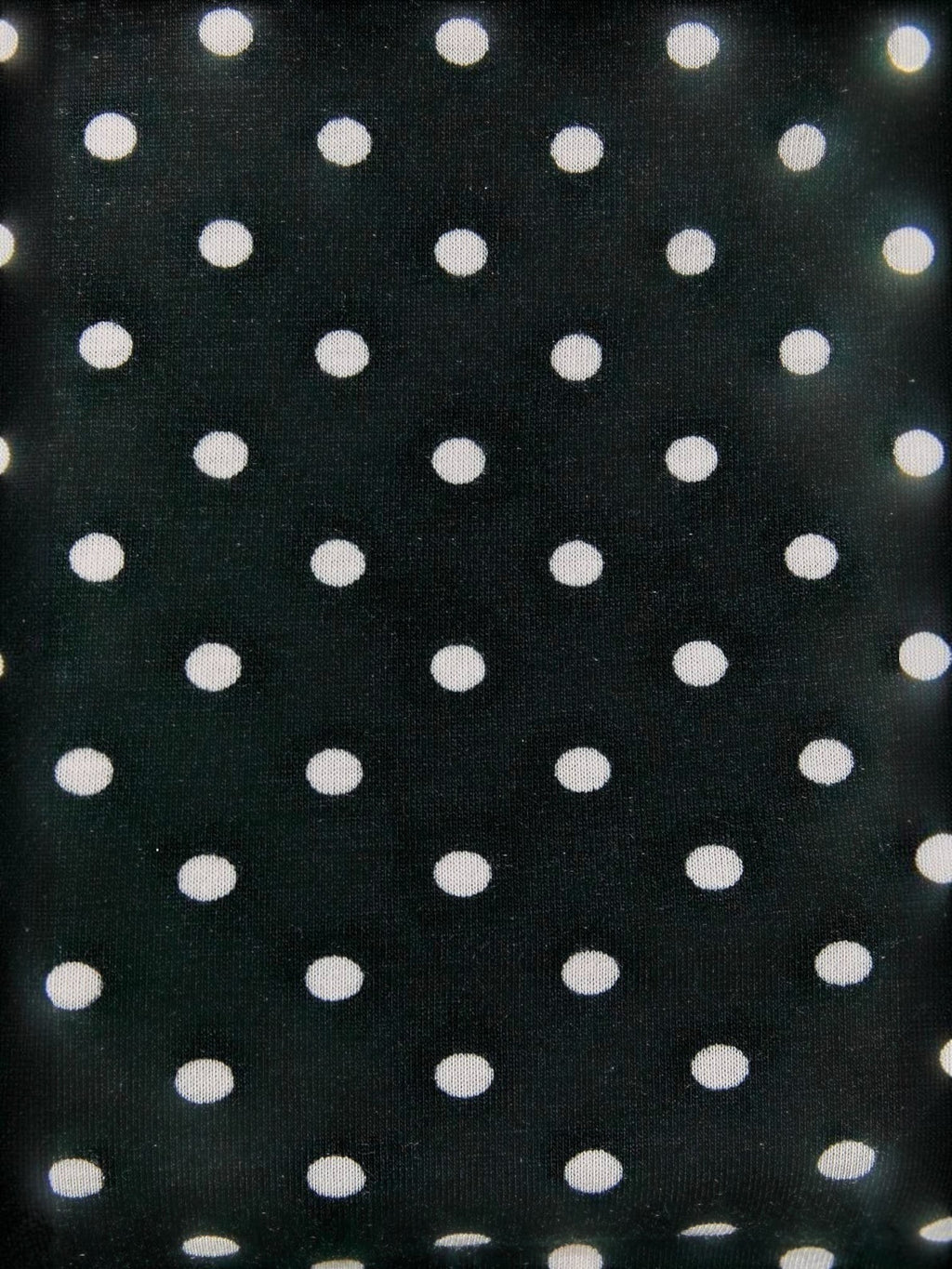 Close-up of the Mialur black and white polka dot stretch knit fabric used for the Luna tank top.