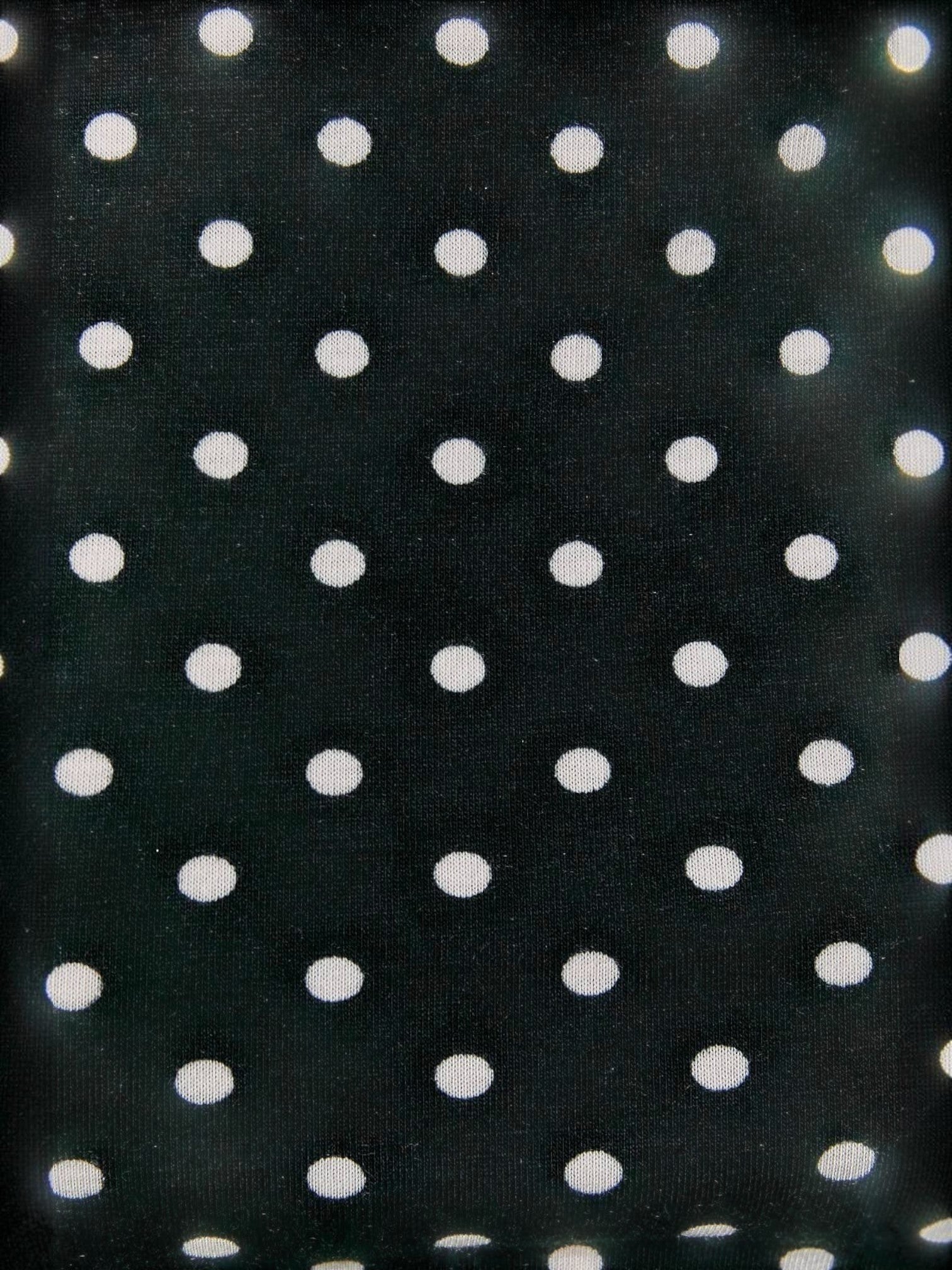 Close-up of the Mialur black and white polka dot stretch knit fabric used for the Luna tank top.
