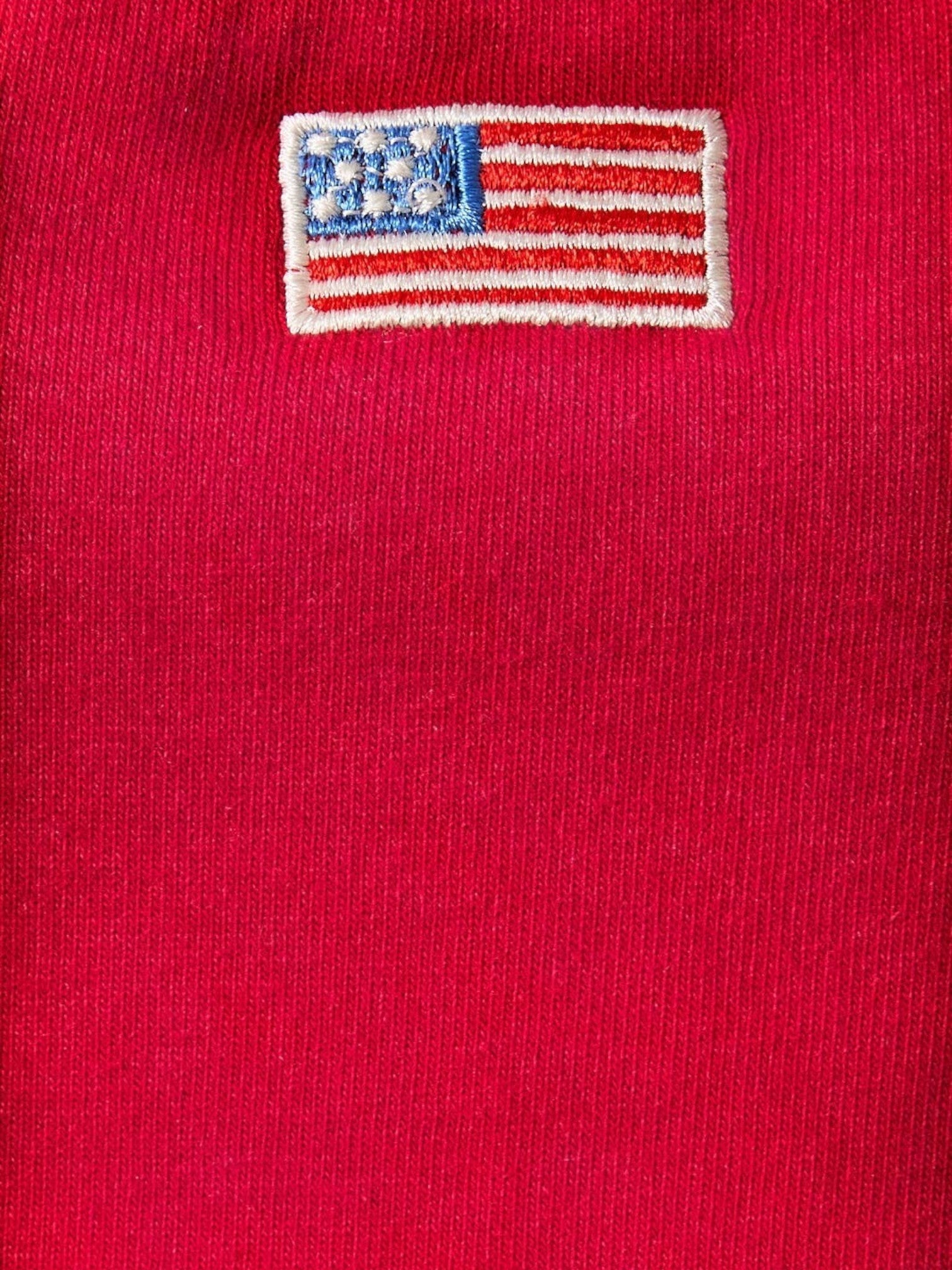 Mialur red halter top fabric detail featuring a small embroidered American flag patch
