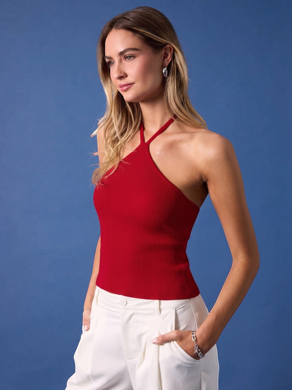 Mialur red ribbed halter top with a fitted silhouette worn by a blonde model against a blue background