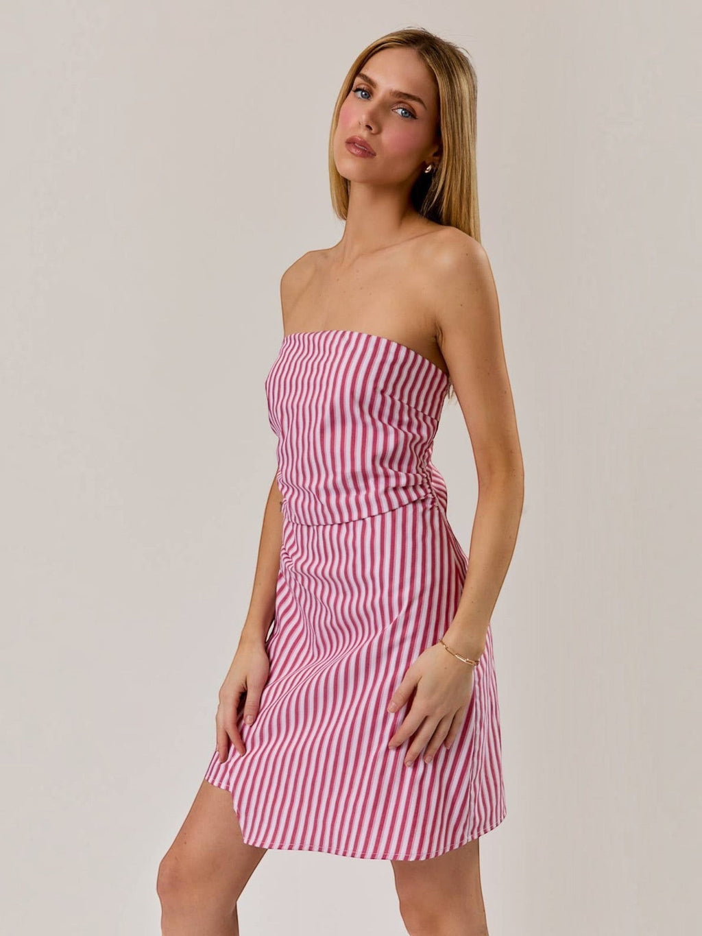 Model wearing a Mialur red and white striped strapless mini dress with a ruched bodice against a neutral background.