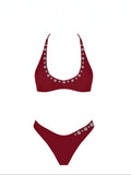 Mialur Ruby Coast bikini set in rich burgundy red with decorative shell-inspired button accents on scoop-neck top