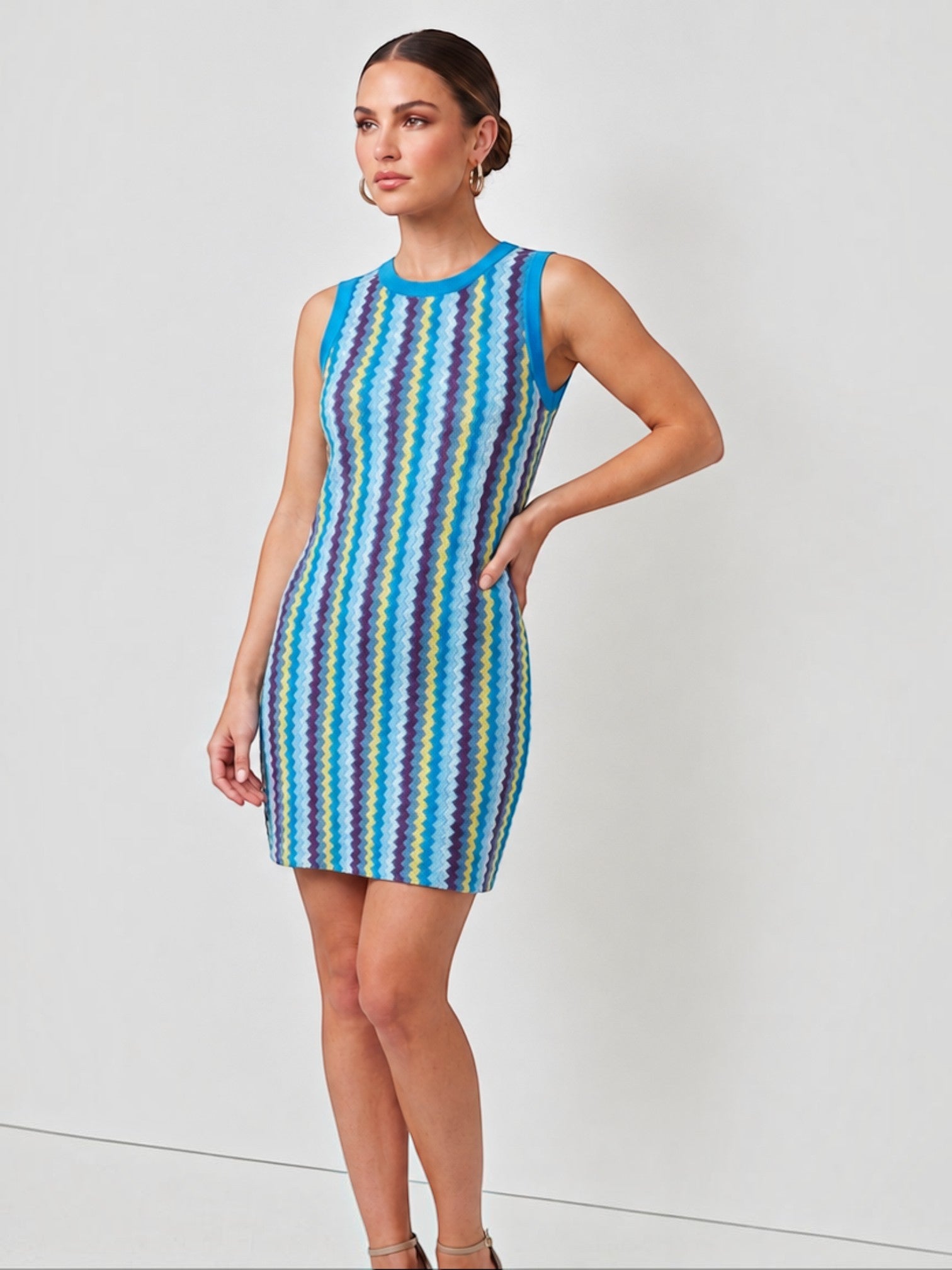 Mialur Santorini knit mini dress featuring a vibrant blue, yellow, and purple zigzag pattern with a round neckline.