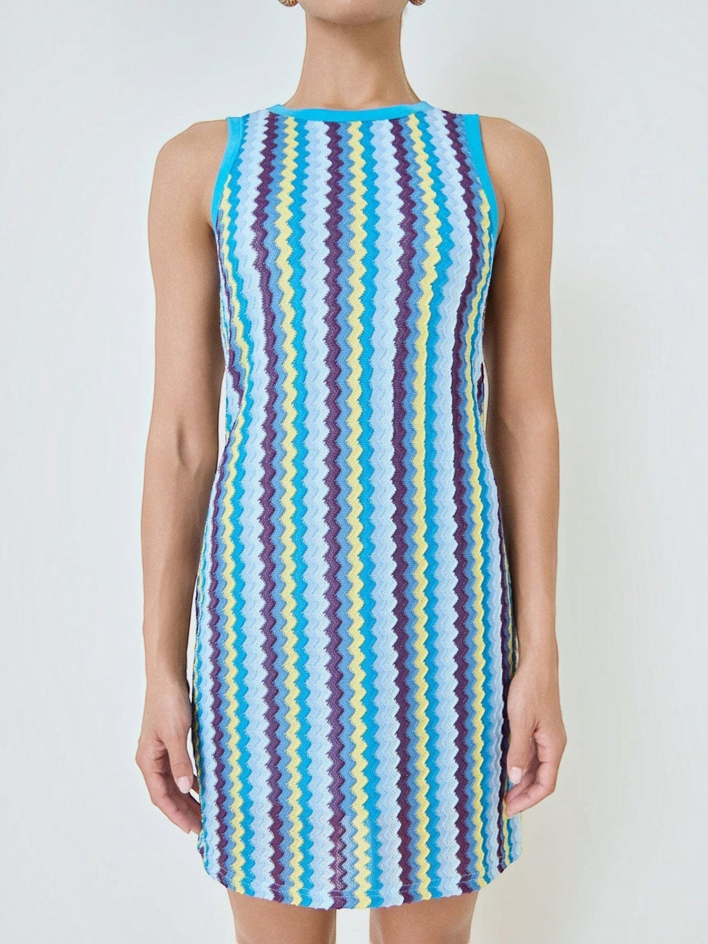Mialur Santorini knit mini dress featuring a vibrant blue, yellow, and purple zigzag pattern with a round neckline.