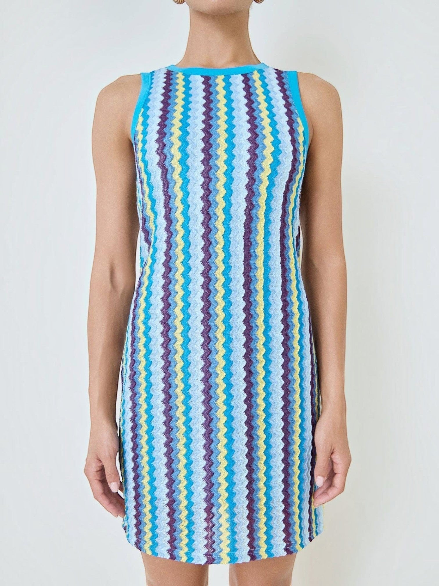 Mialur Santorini knit mini dress featuring a vibrant blue, yellow, and purple zigzag pattern with a round neckline.