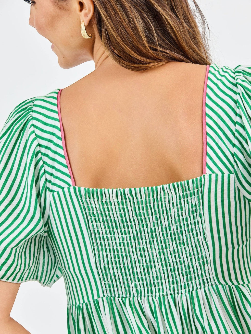 Back view of Mialur Savannah dress featuring green and white stripes, square neckline, and smocked bodice detail.