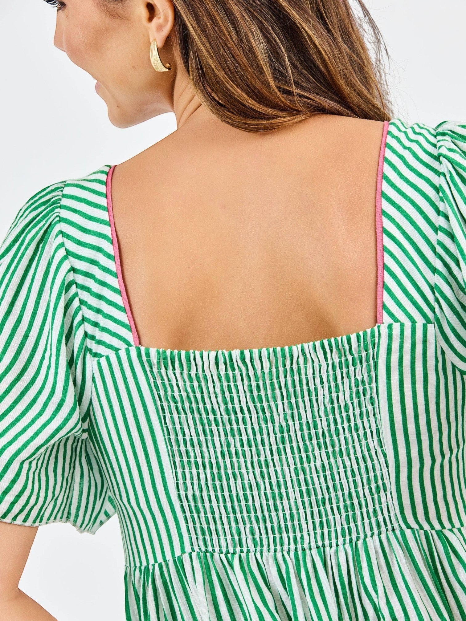 Back view of Mialur Savannah dress featuring green and white stripes, square neckline, and smocked bodice detail.