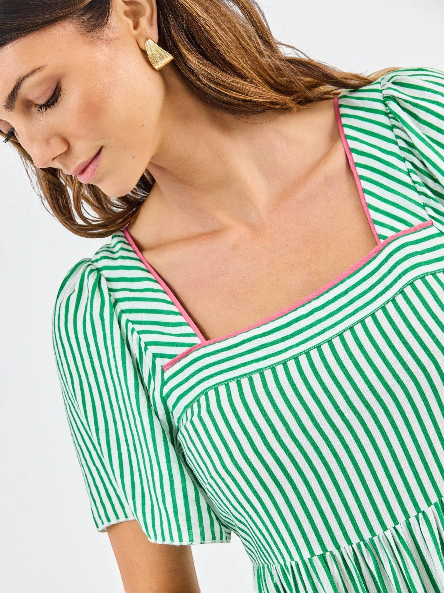 Mialur Savannah dress featuring a green and white striped pattern, square neckline with pink trim, and puff sleeves.