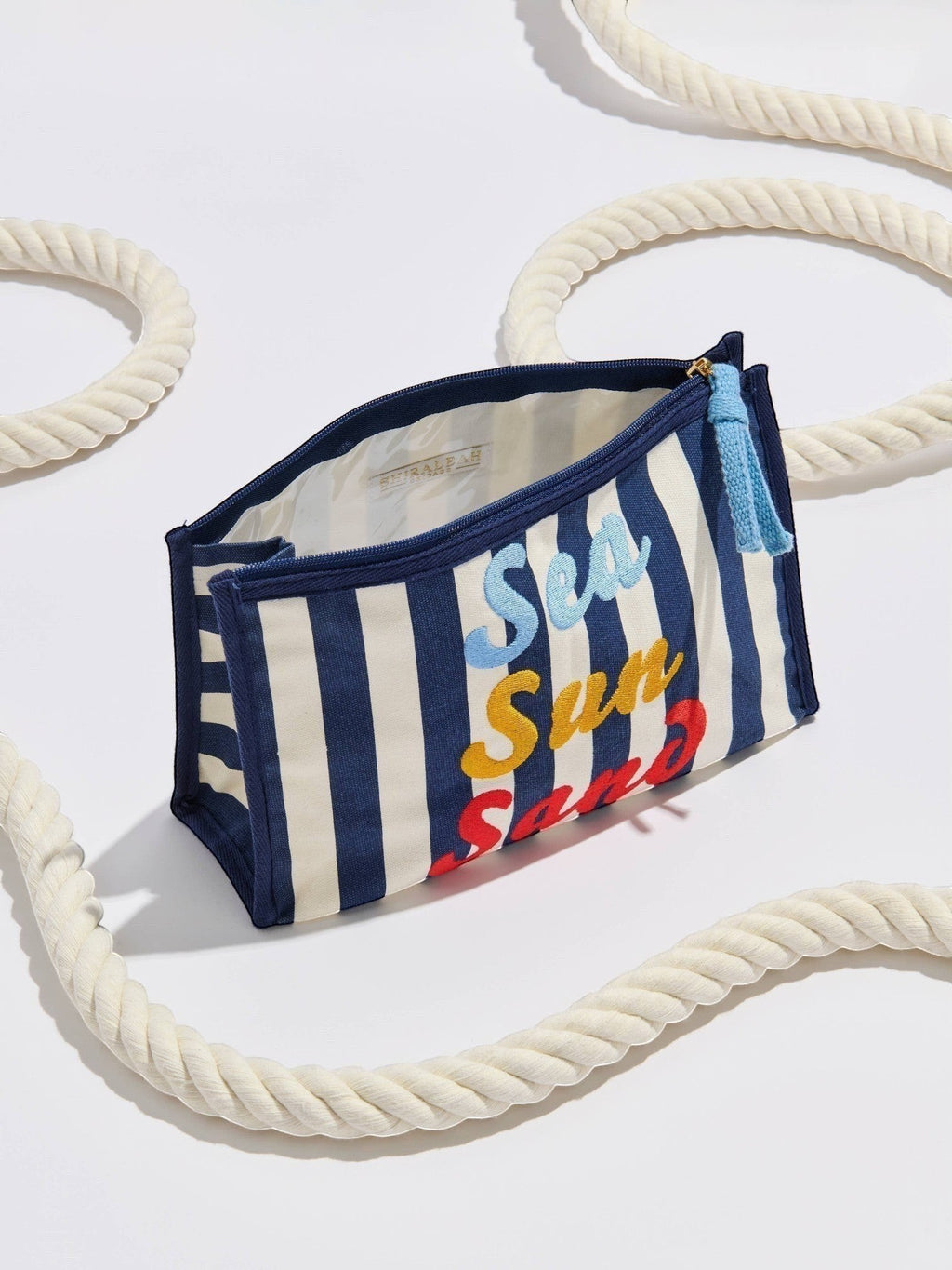 Mialur navy and white striped canvas zip pouch with colorful Sea Sun Sand embroidery and a blue tassel zipper pull.