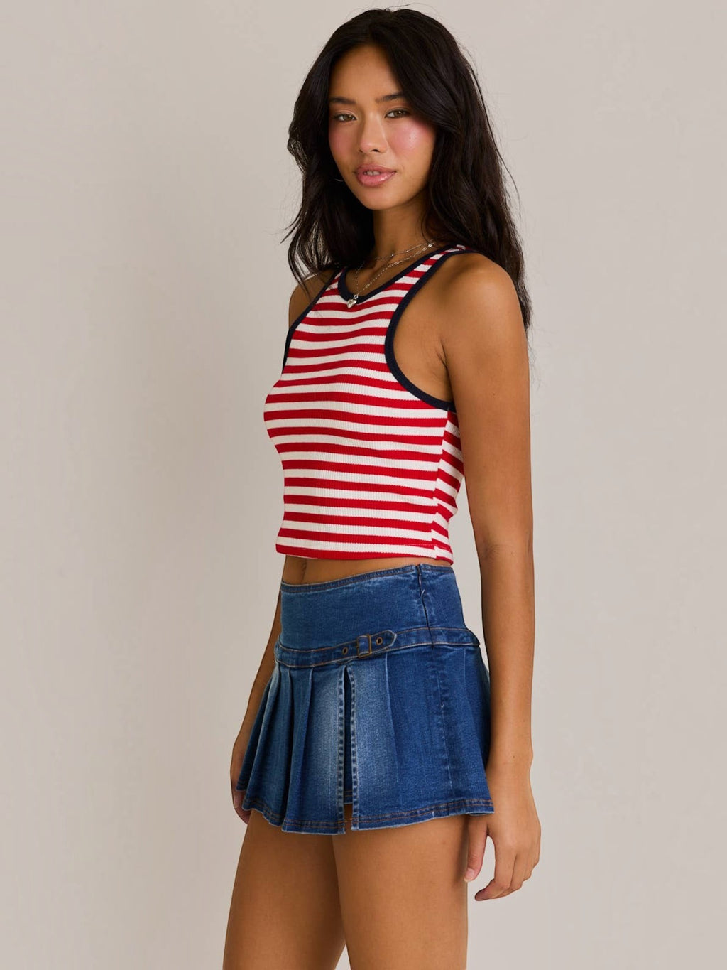 Mialur cropped tank top with red and white horizontal stripes and navy trim worn by a model with a denim mini skirt