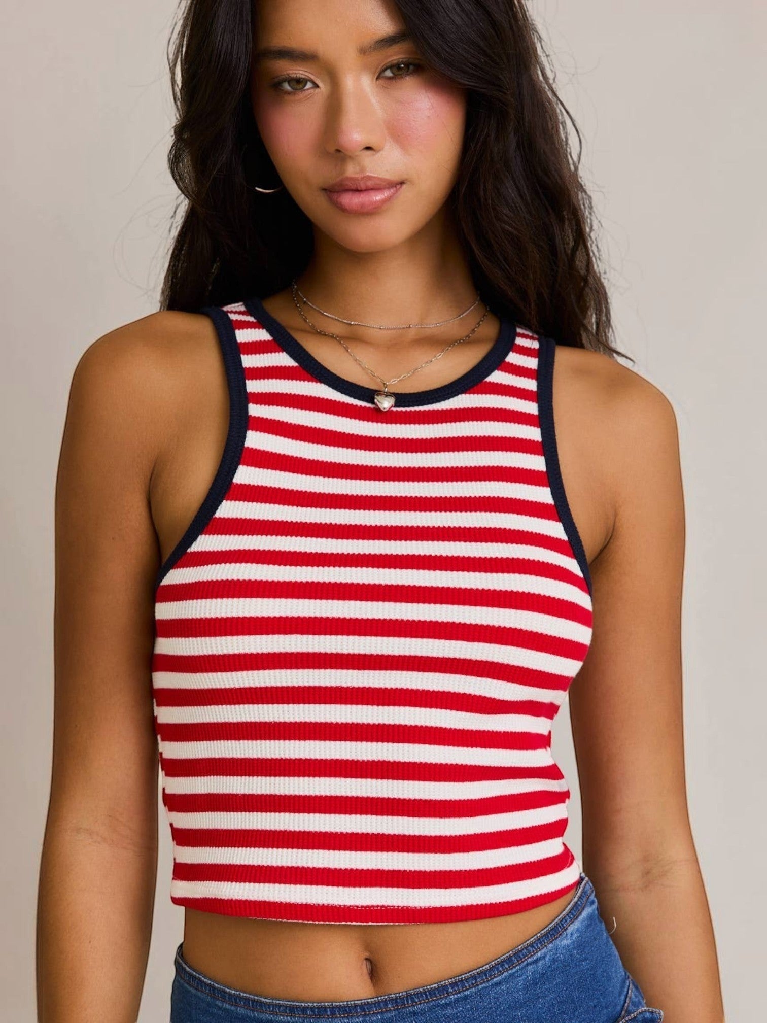 Model wearing a Mialur red and white horizontal striped cropped tank top with navy blue trim and a scoop neckline.