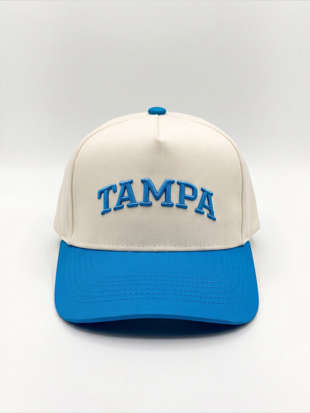 Mialur Tampa Coastal Hat in cream with a blue brim and blue embroidered TAMPA lettering on the front.