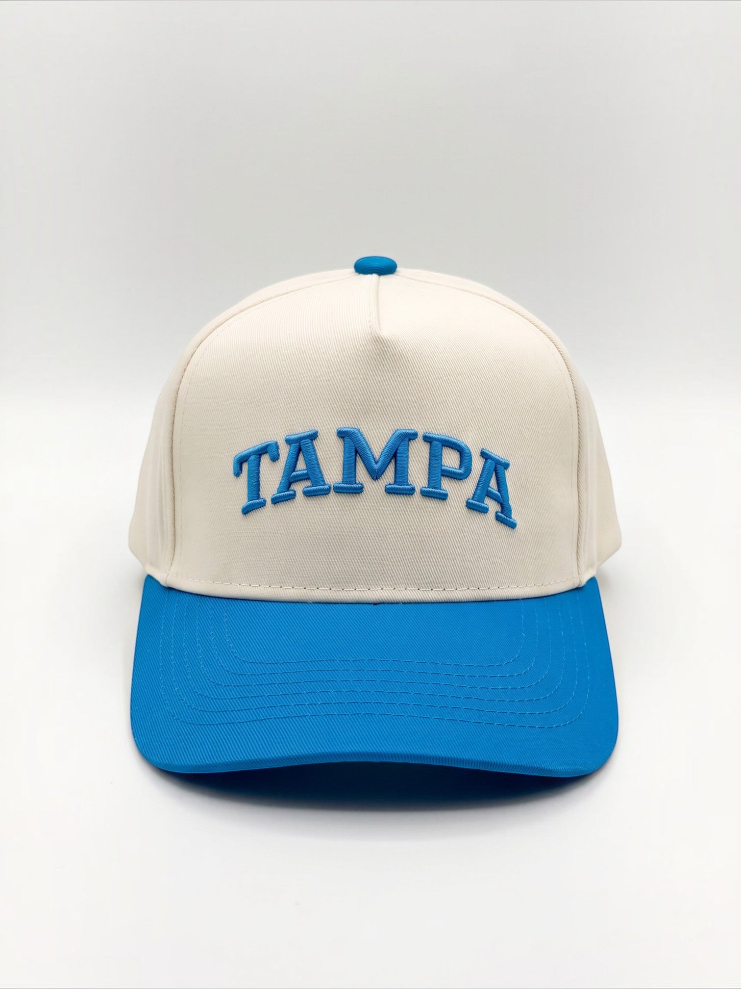 Mialur Tampa Coastal Hat in cream with a blue brim and blue embroidered TAMPA lettering on the front.