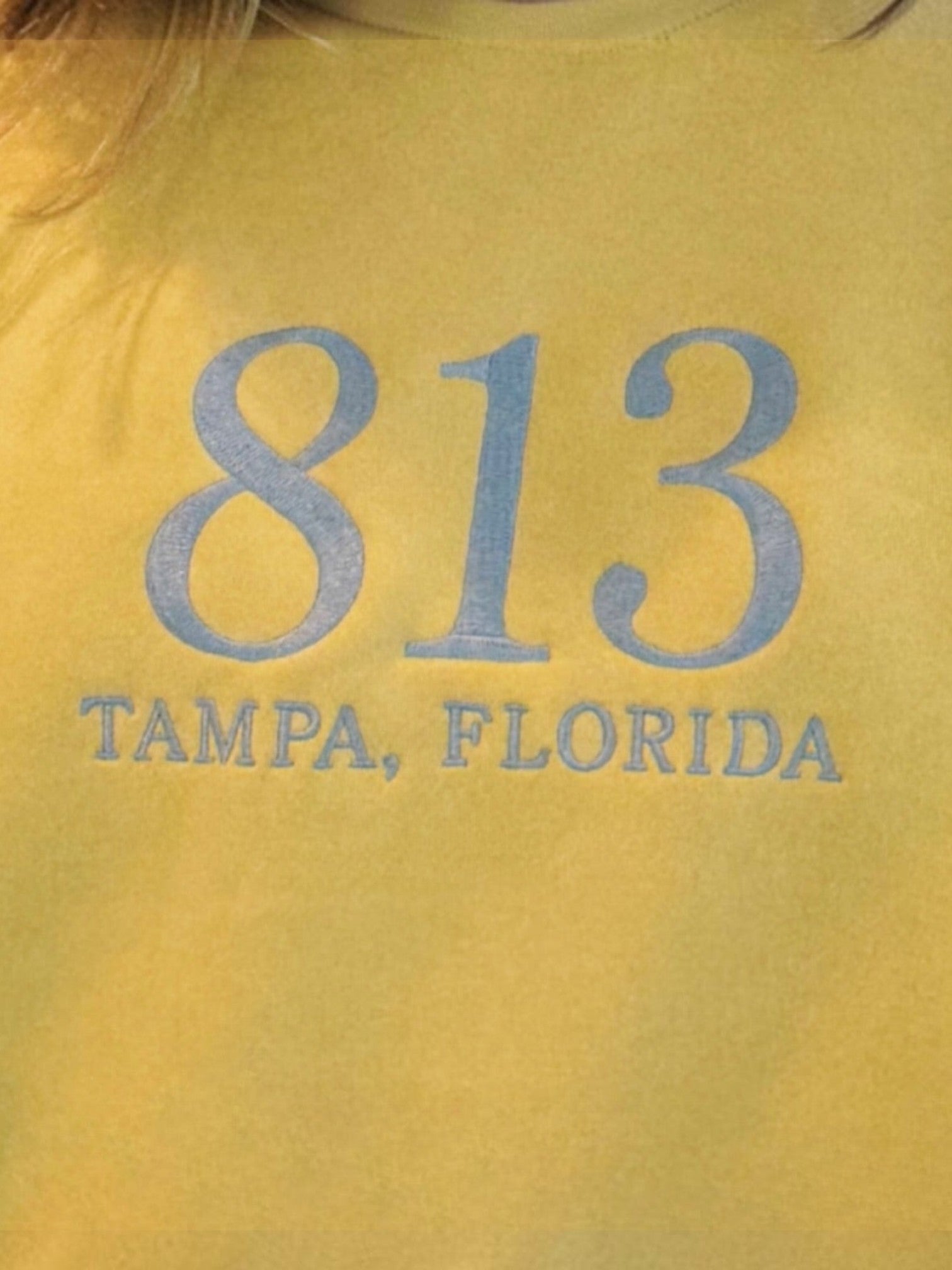 Mialur yellow cotton-blend mock neck top featuring 813 Tampa Florida collegiate-style graphic lettering