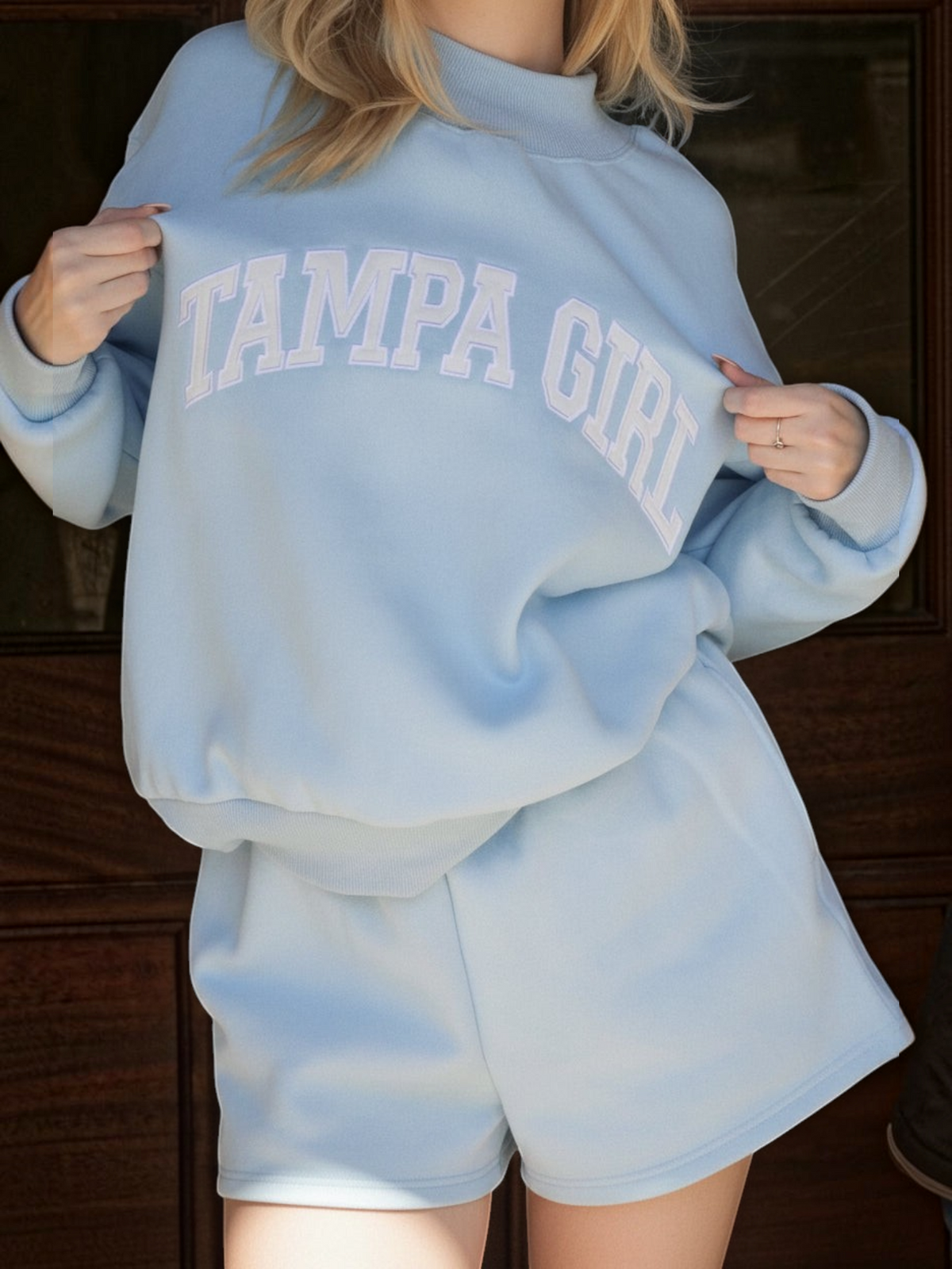 Mialur light blue mock neck sweatshirt and shorts set with white TAMPA GIRL lettering on a model