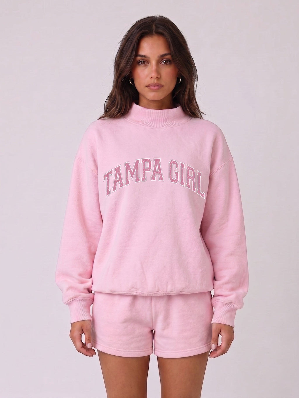 Mialur light pink mock neck sweatshirt and matching shorts set with TAMPA GIRL graphic lettering on a model