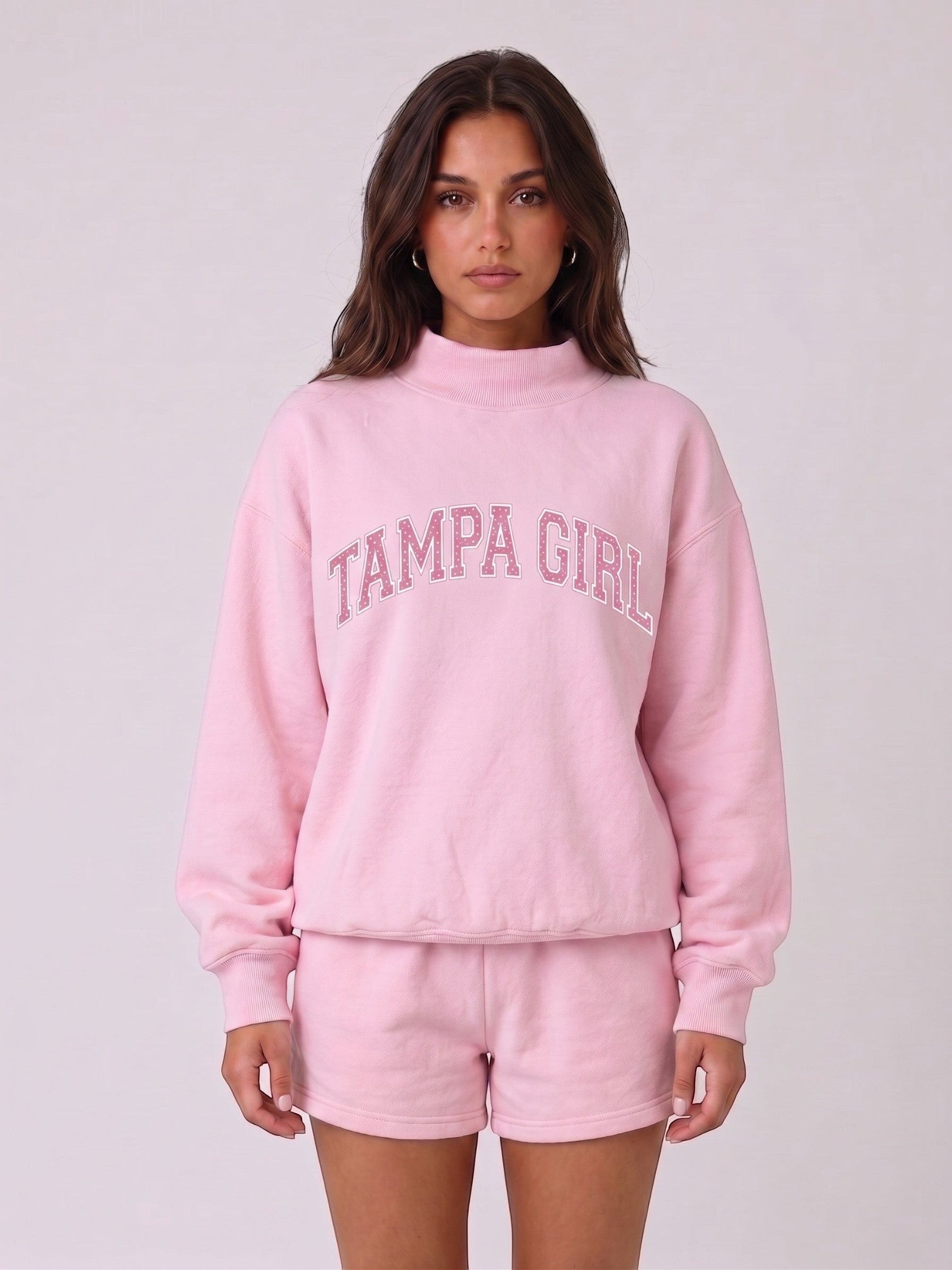 Mialur light pink mock neck sweatshirt and matching shorts set with TAMPA GIRL graphic lettering on a model