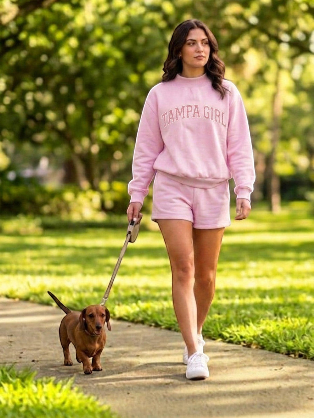 Mialur light pink mock neck sweatshirt and shorts set with TAMPA GIRL lettering worn by a woman walking a dog