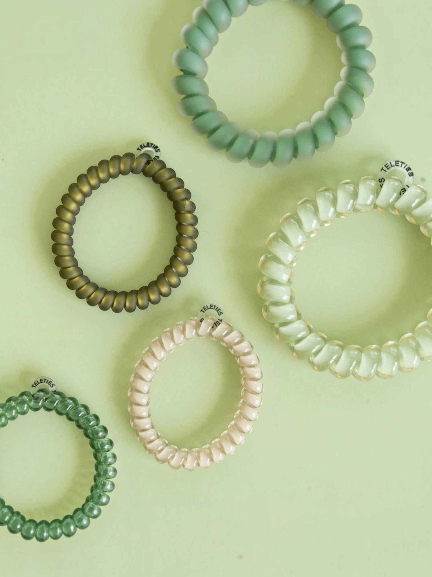 Mialur TELETIES Mossy Moments spiral hair ties in olive and sage green shades, featuring five coil hair accessories.