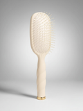 Mialur TELETIES tan detangler hair brush for medium hair with a coil-inspired grip and gold base detail.