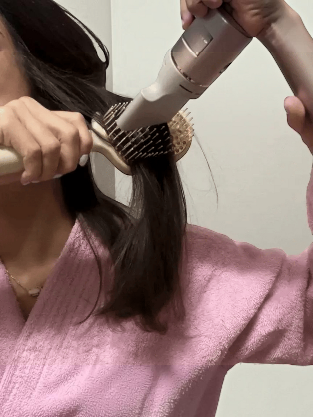 Mialur TELETIES tan vented hair brush with aluminum plate being used with a hair dryer for a smooth blowout.