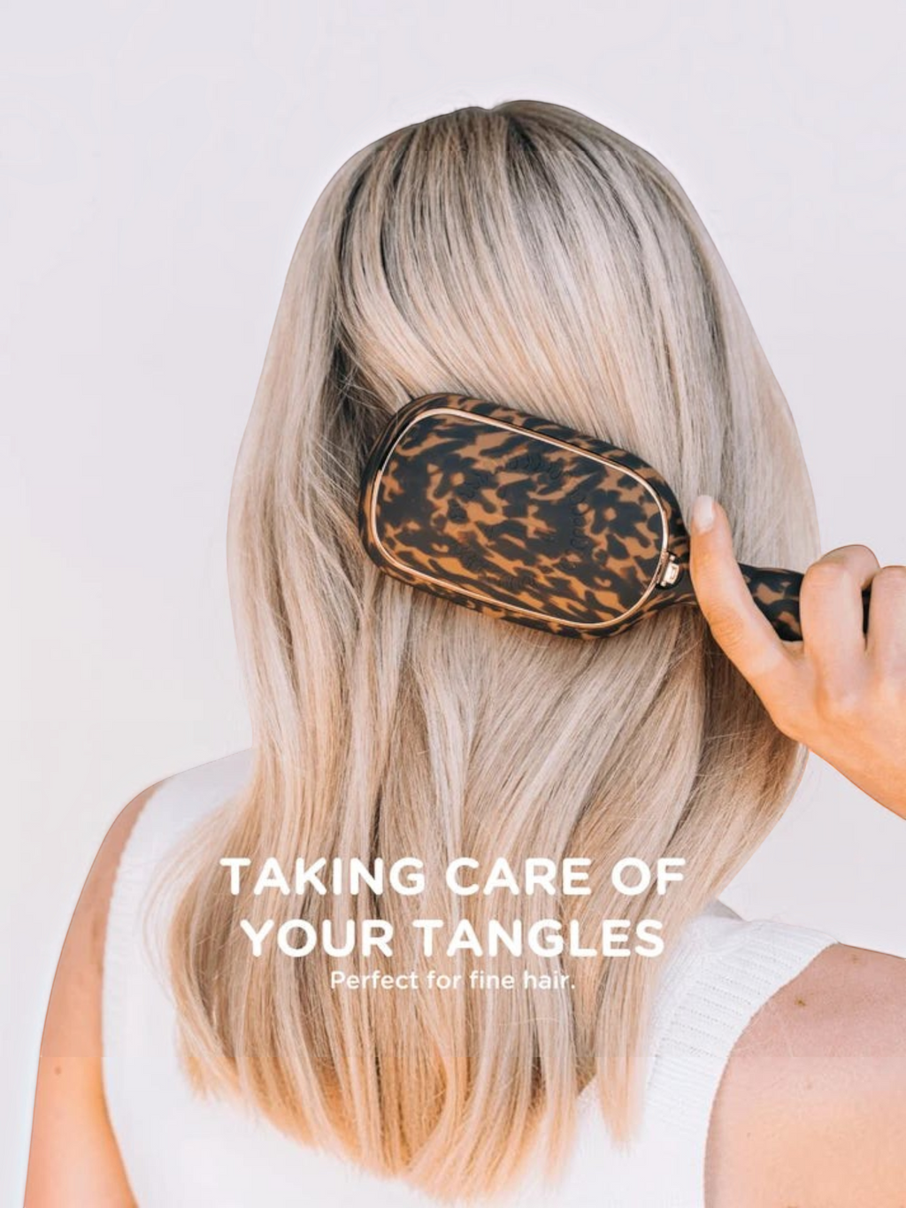 Mialur TELETIES detangler hair brush in tortoise print being used on blonde hair to gently brush through tangles.